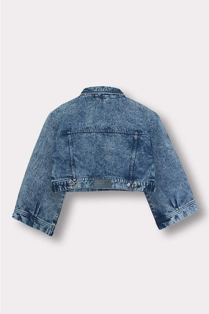 Close-up of the chest pocket and collar on the acid wash denim jacket.