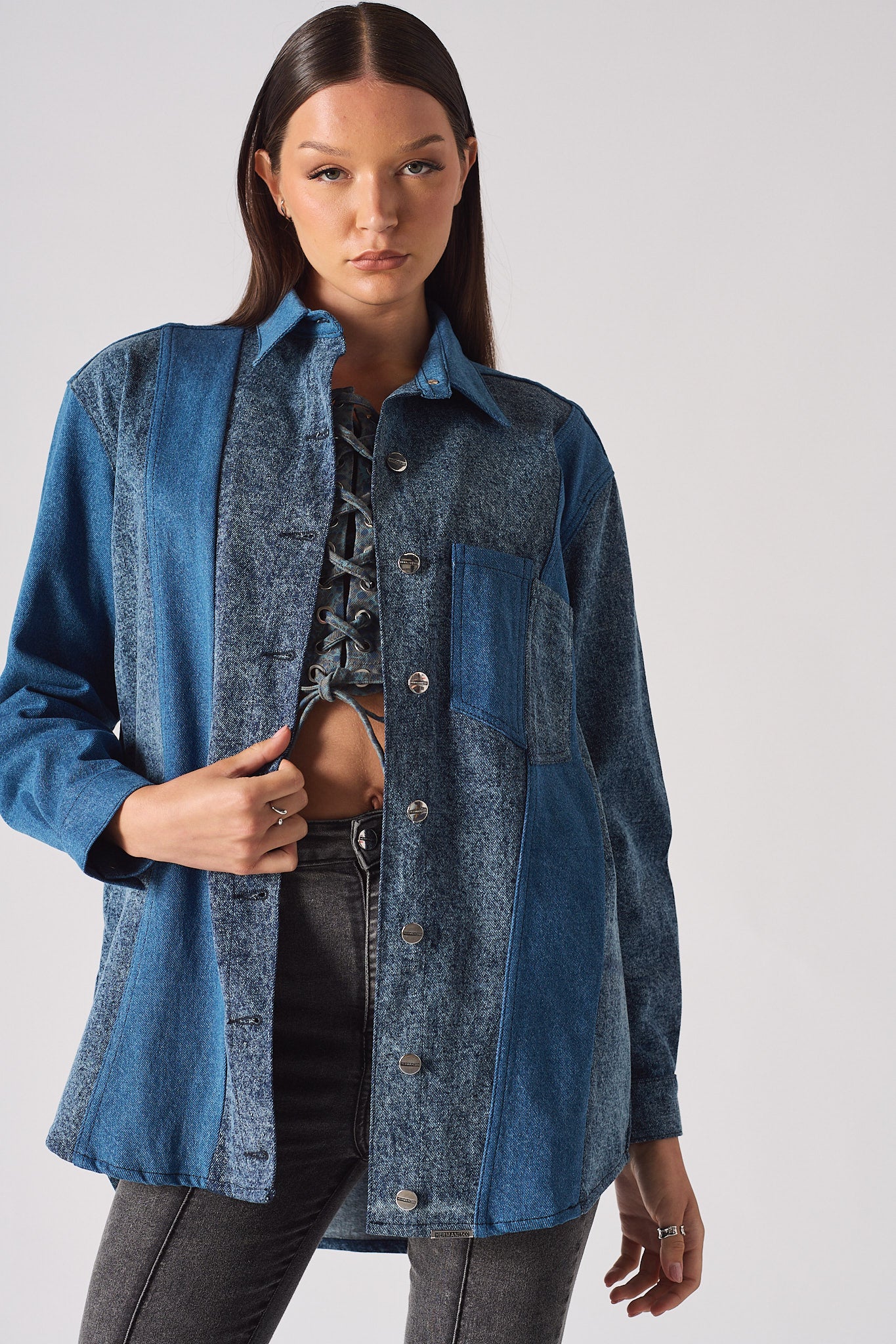 Full view of a model wearing the blue acid wash denim shirt.