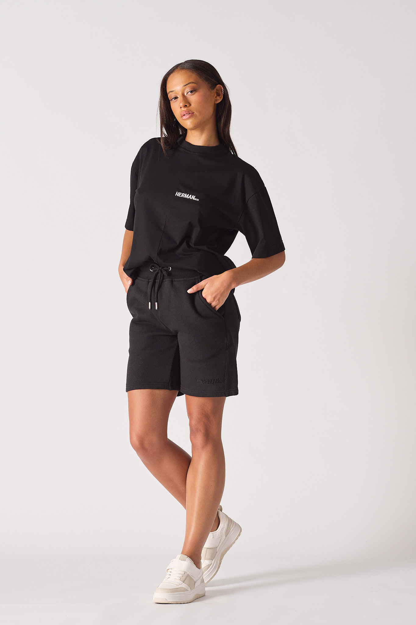 Model standing wearing black aline shorts womens with a relaxed fit