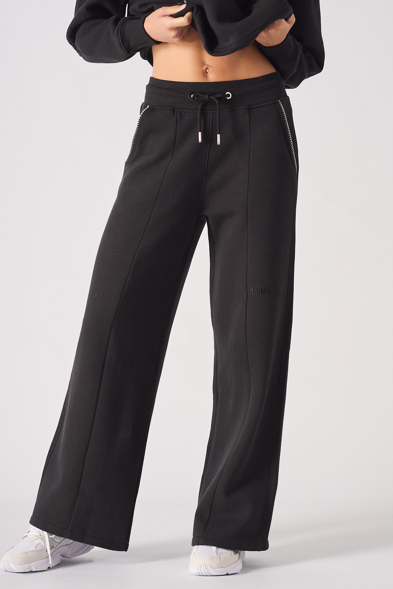 Rear view of womens black wide leg joggers showing the full length fit