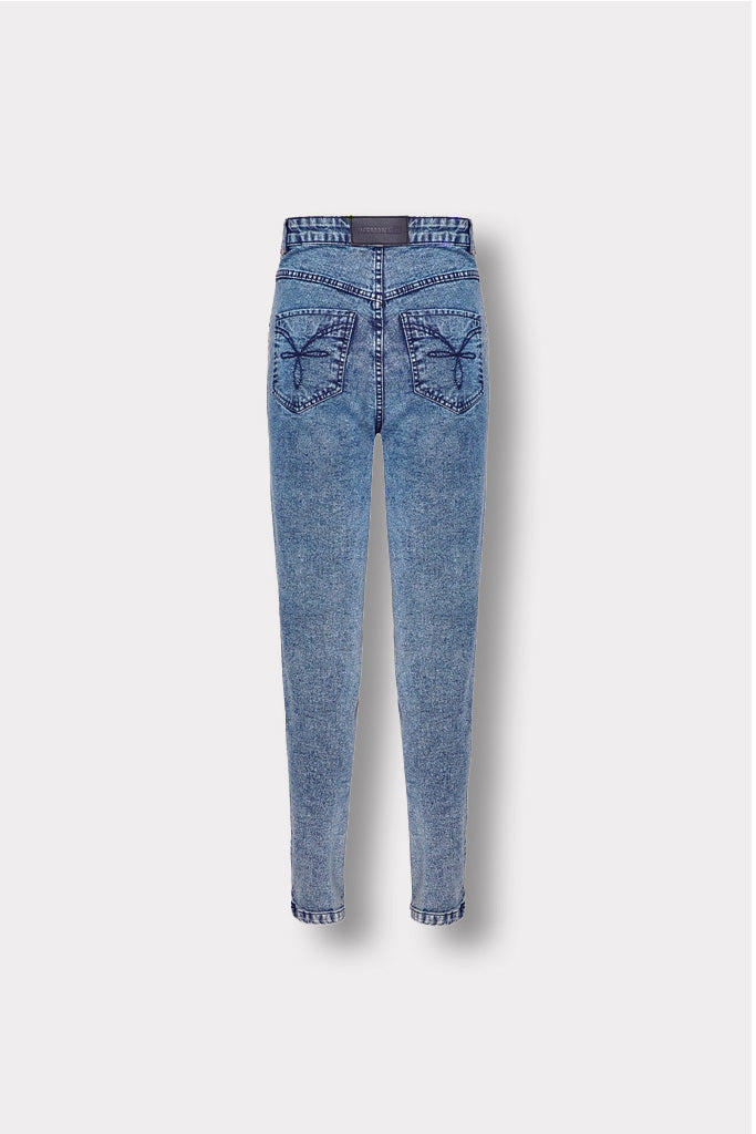 Back view of the blue acid wash skinny jeans with logo patch, laid flat