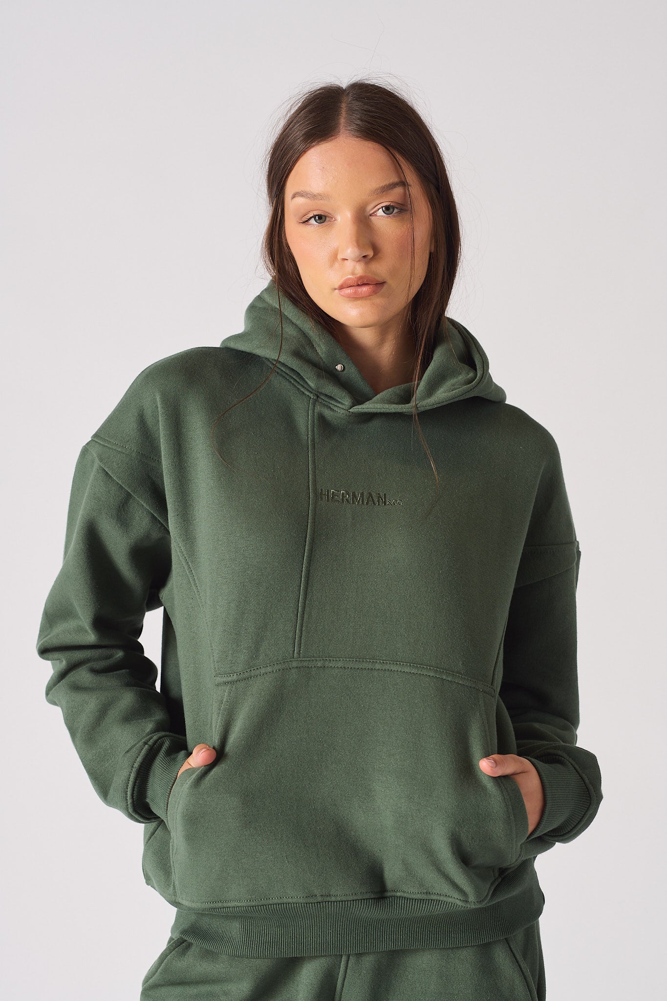 Close up of the hood neck on a womens dark green sweatshirt