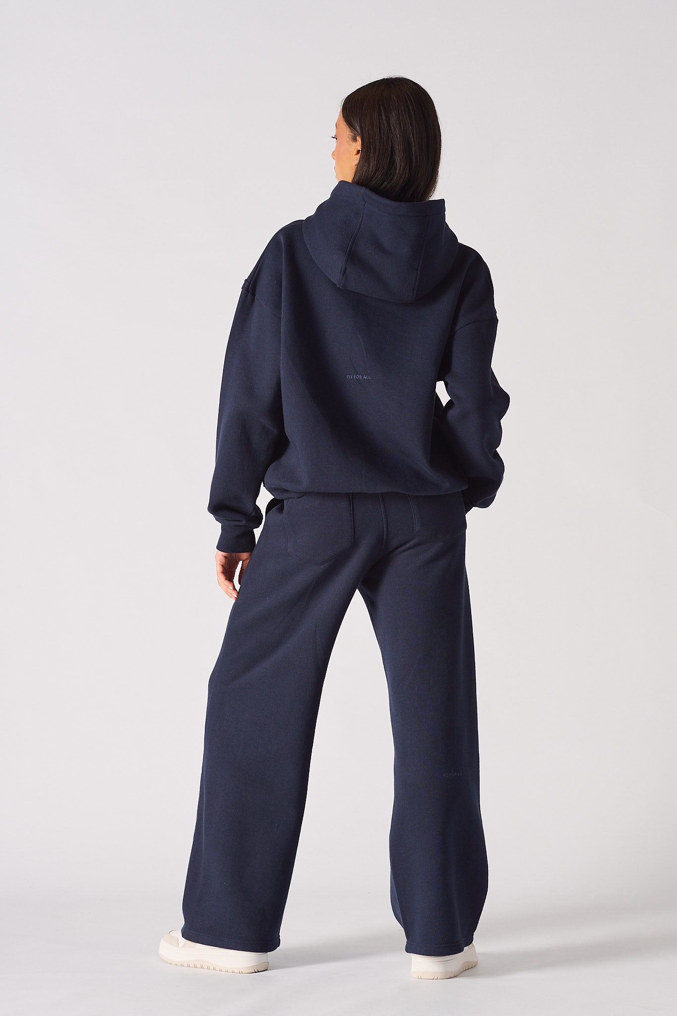 Rear view of womens dark green hoodie with relaxed fit