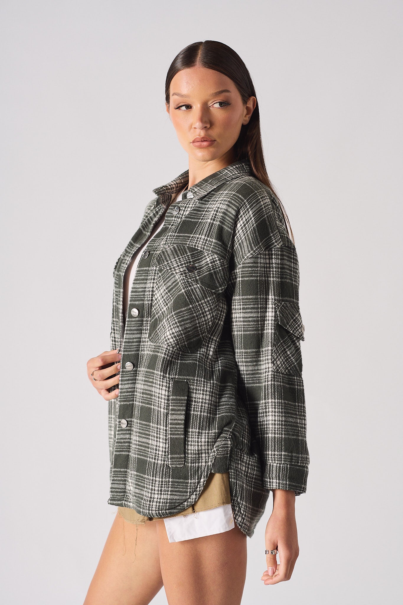 Angled view of the women's green check oversized shirt.