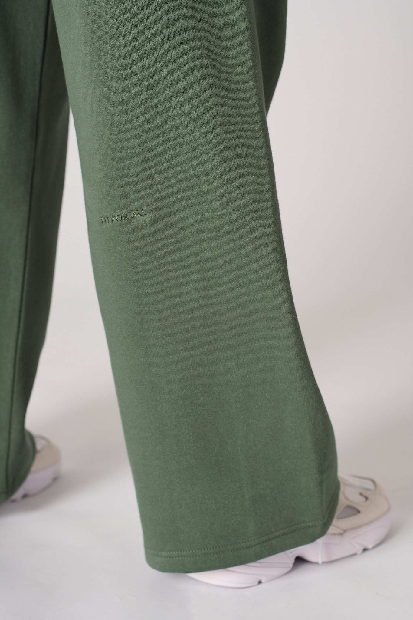 Another close-up of the hem on the green wide-leg joggers for women.
