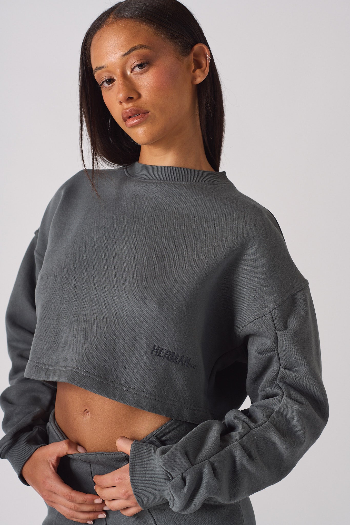 Mid shot of model wearing a grey crew neck jumper womens with gathered sleeves