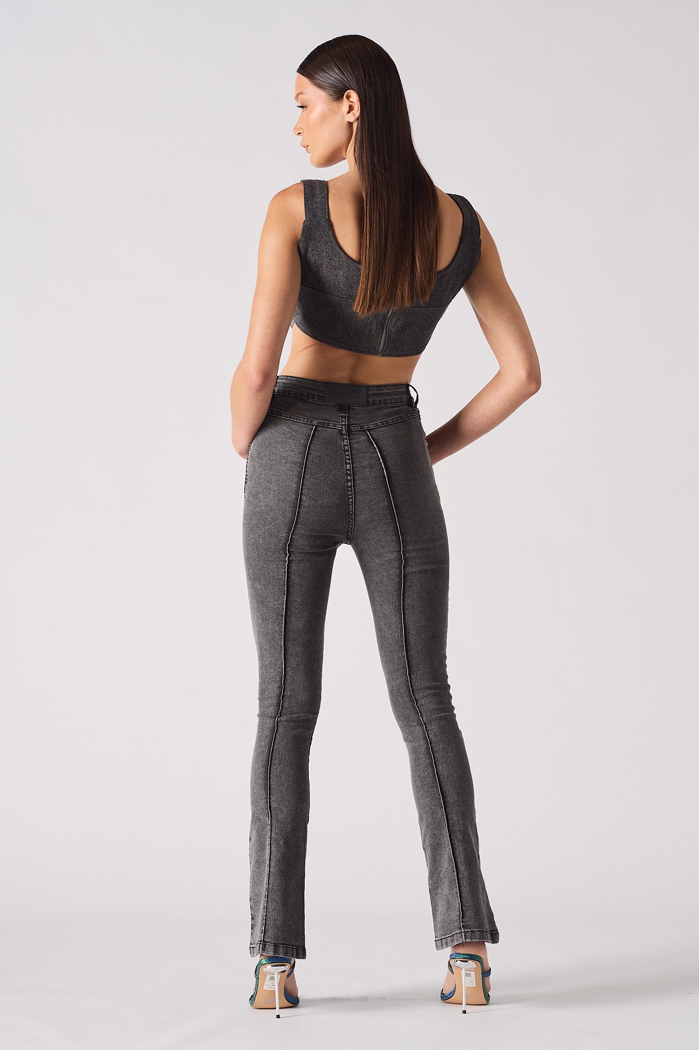 Back view of a model in the grey flare jeans.