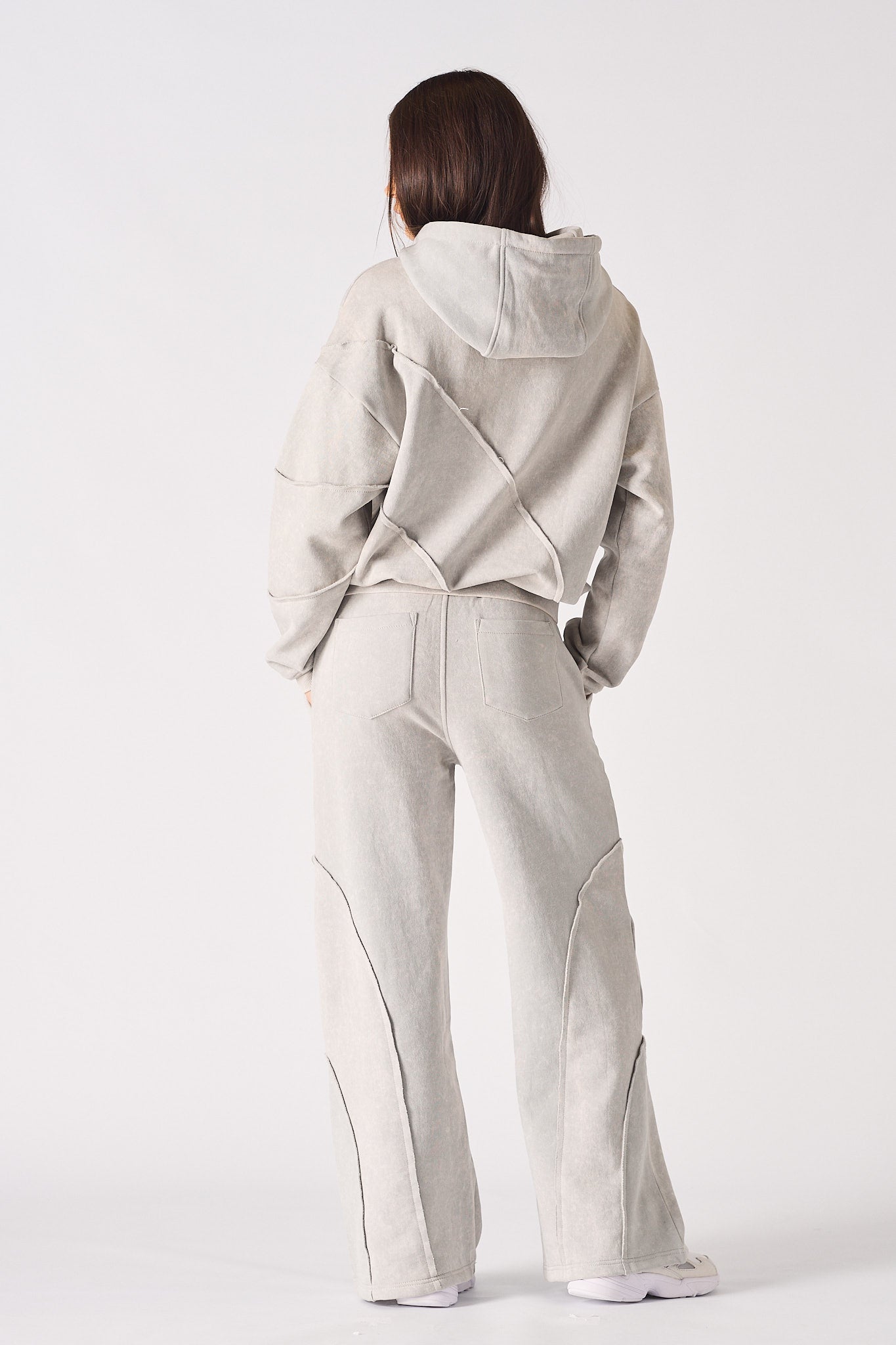 Rear full body view of model in a relaxed fit womens oversized grey hoodie outfit