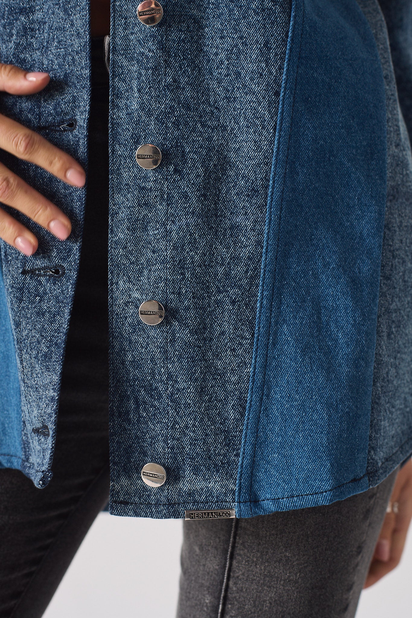 A model showing the fit of the longline acid wash denim shirt for women.