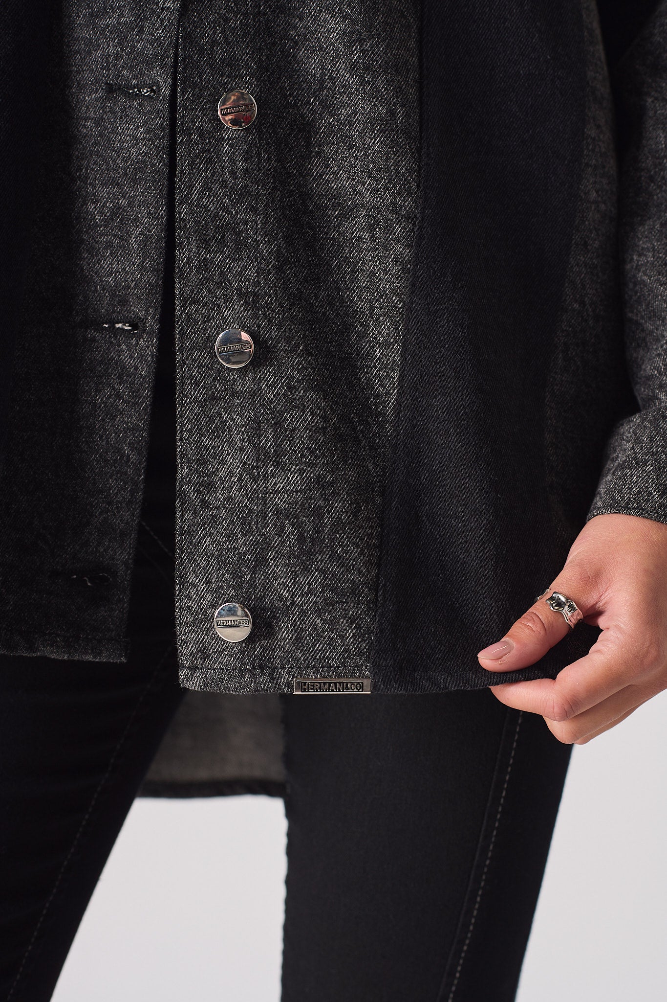 Close-up of the curved hem on the women's longline acid wash shirt.