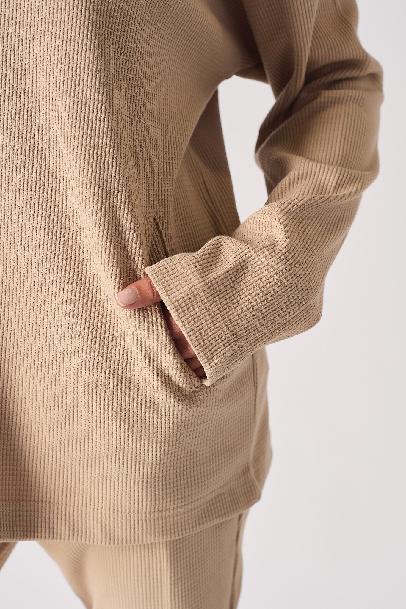Detailed texture view of the soft brushback fabric on beige jumper