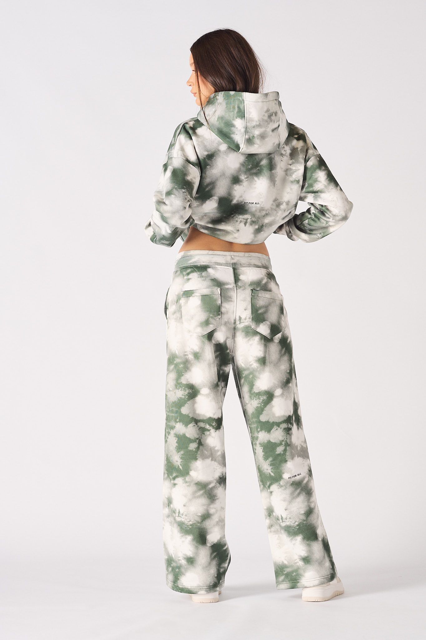 Back view of a model in the tie-dye wide-leg joggers and matching hoodie.