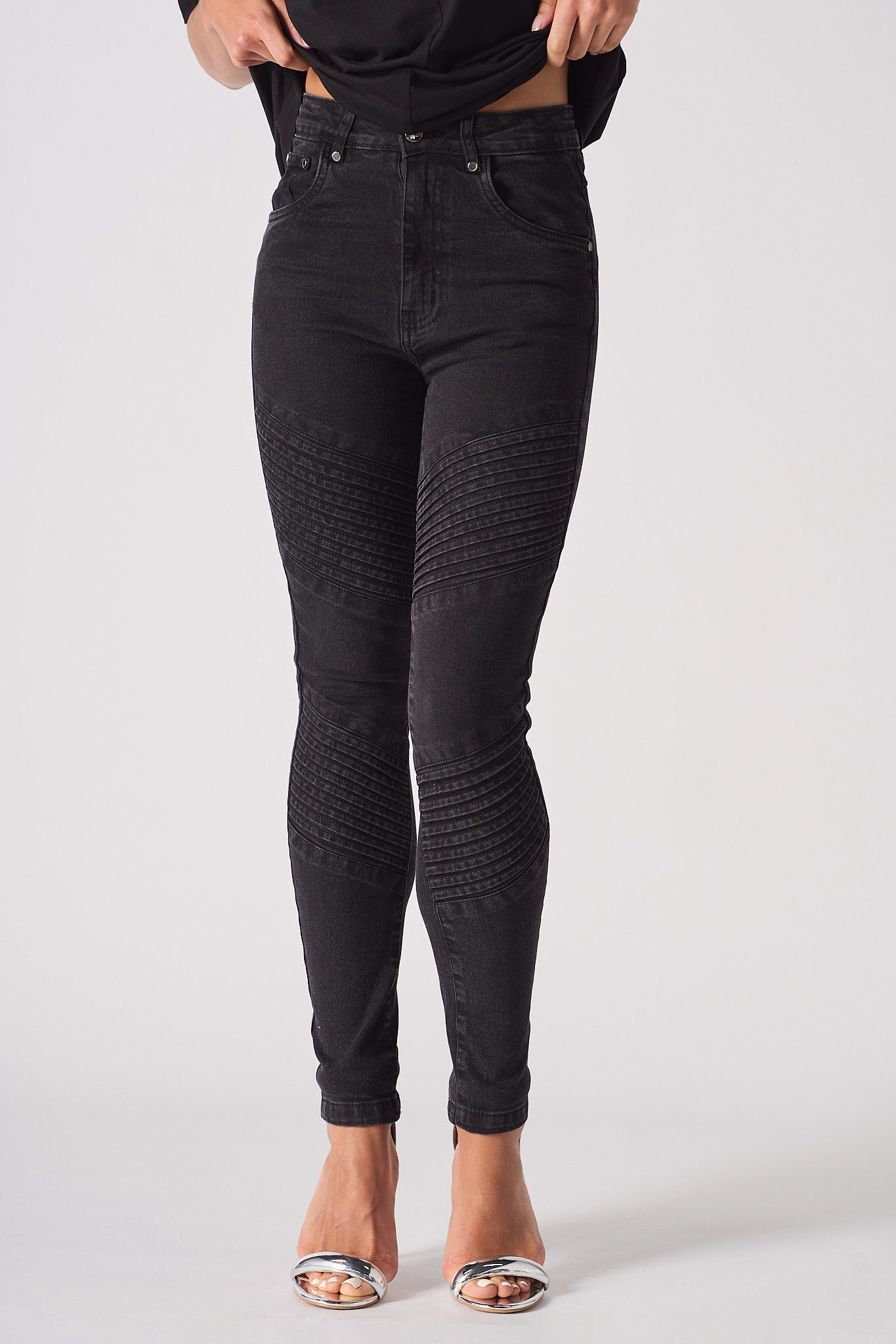 Front view of the women's black jeans in a biker style.