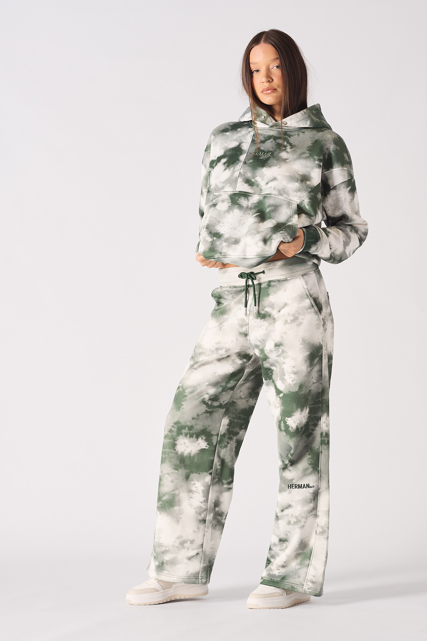 A model wearing the full women's green and white tie-dye tracksuit set.