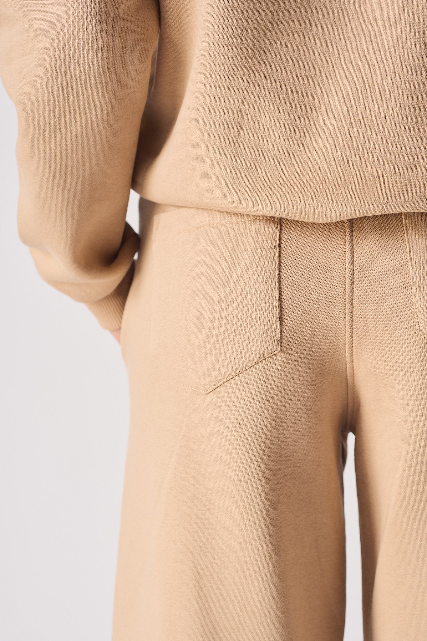 Another close-up of the back pocket on the women's beige joggers.