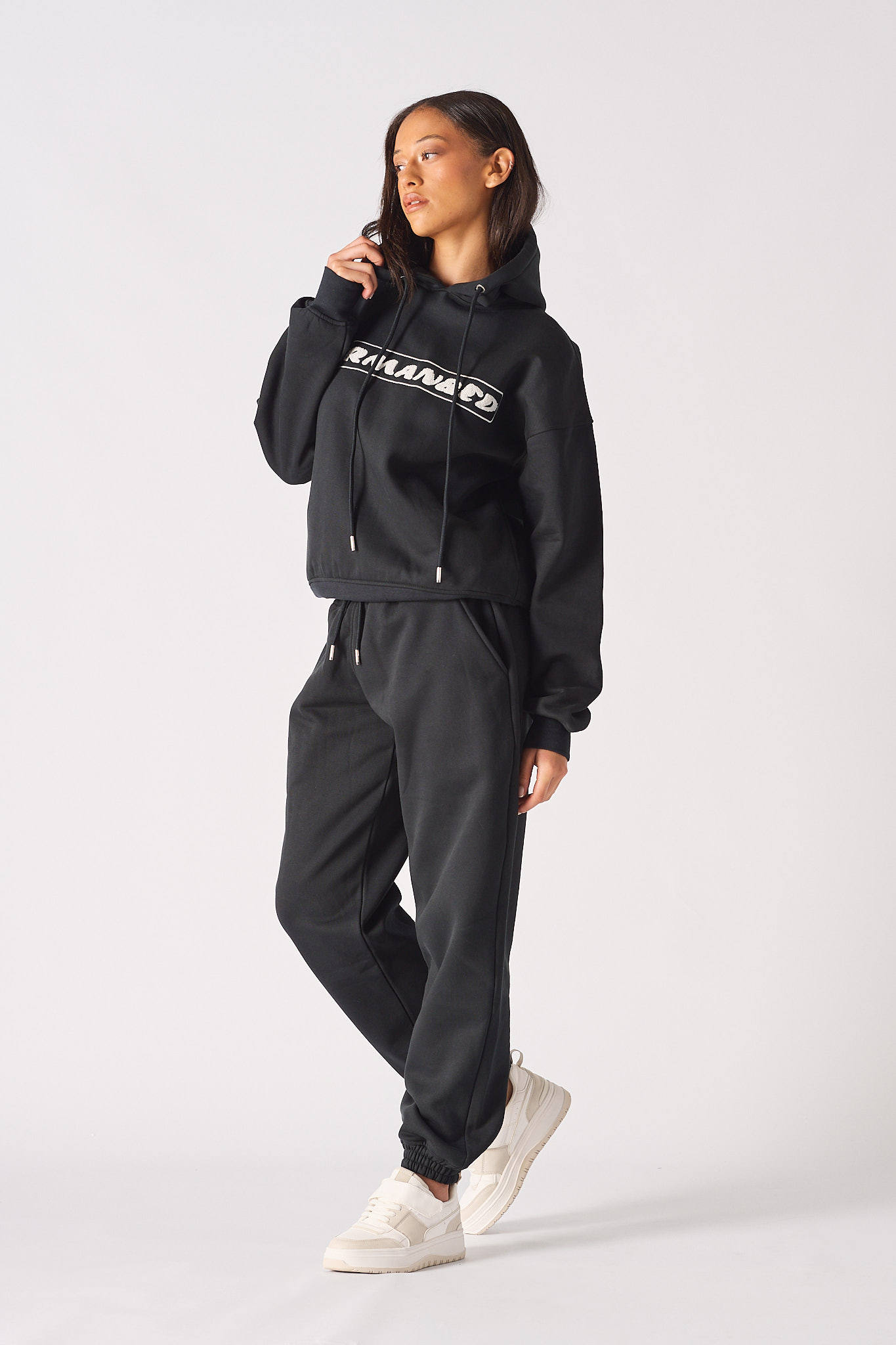 Close up detail of the ribbed sleeve cuff on womens black oversized hoodie