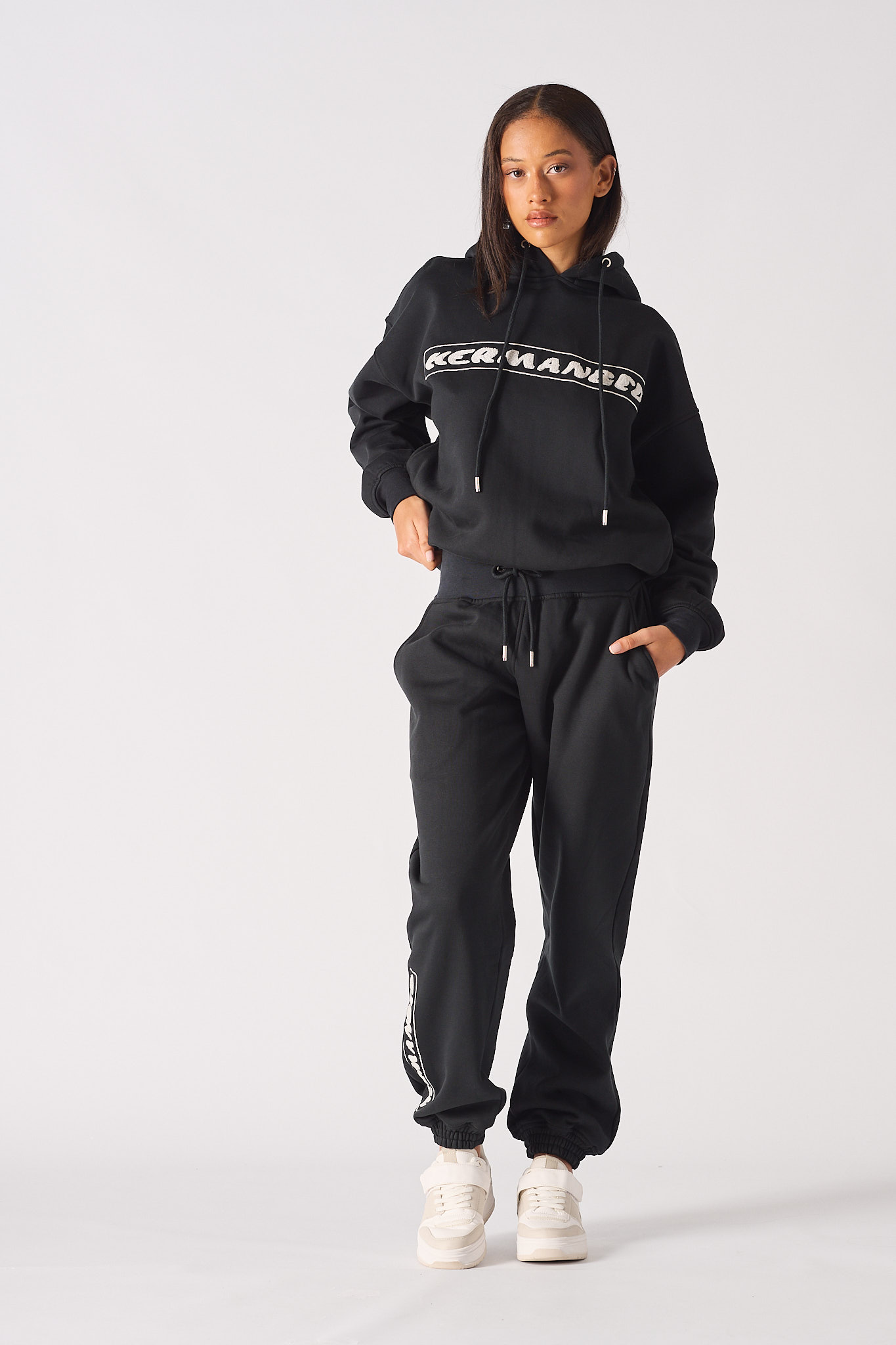 Back view of model standing in black oversized joggers showing loose fit