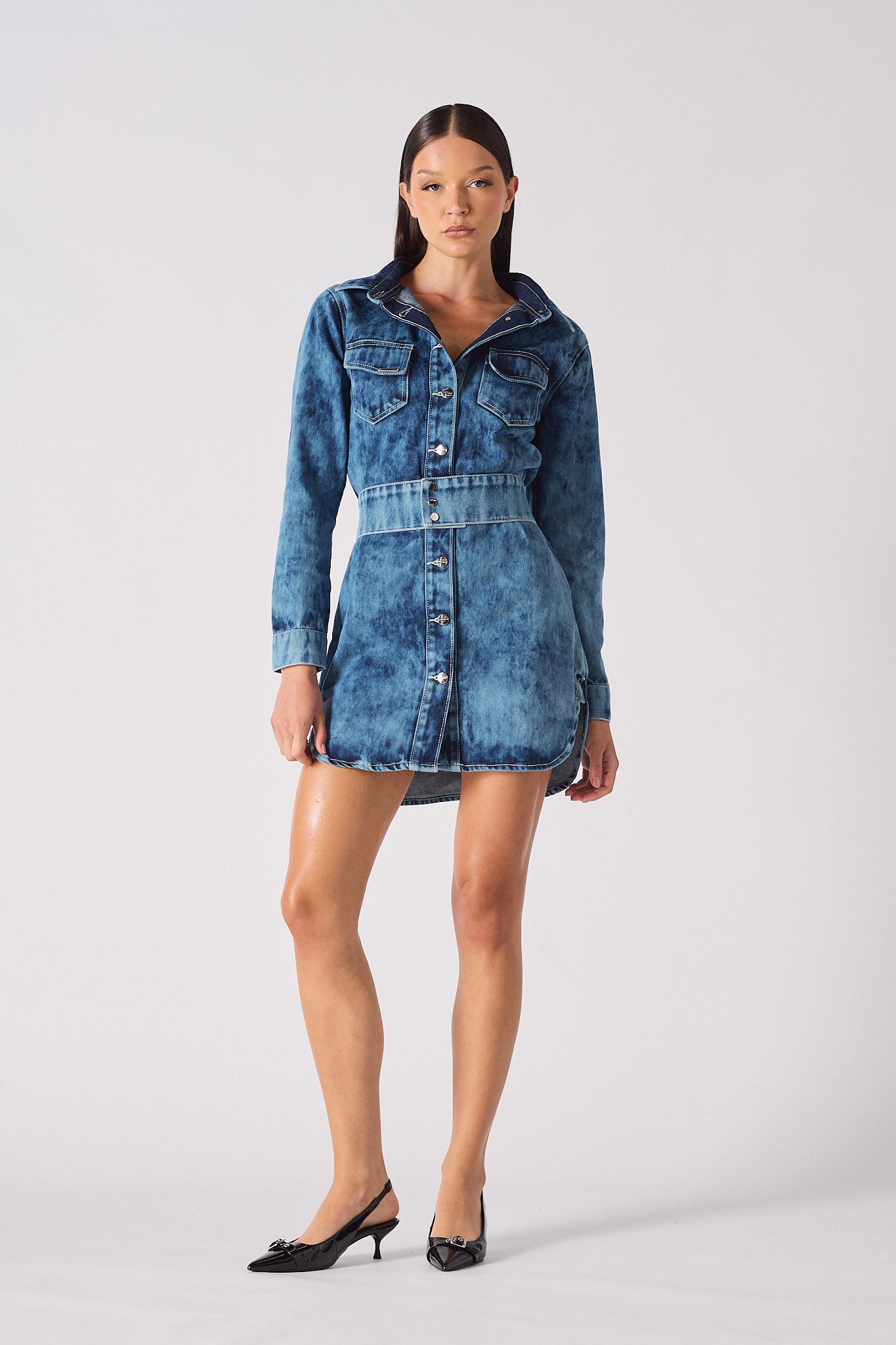 Front view of a model wearing the women's blue acid wash denim dress