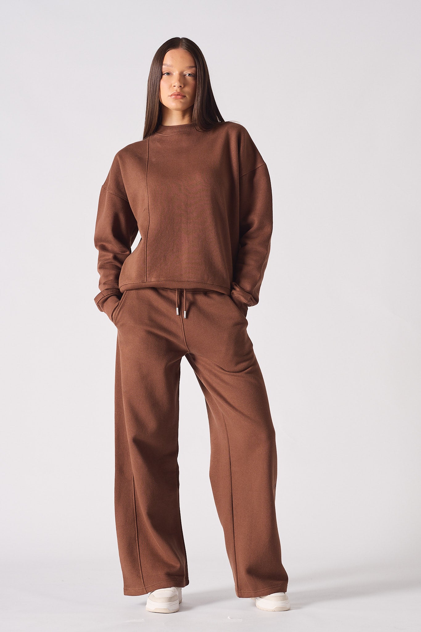 Full length view of model wearing a brown crew neck jumper womens with matching wide leg trousers