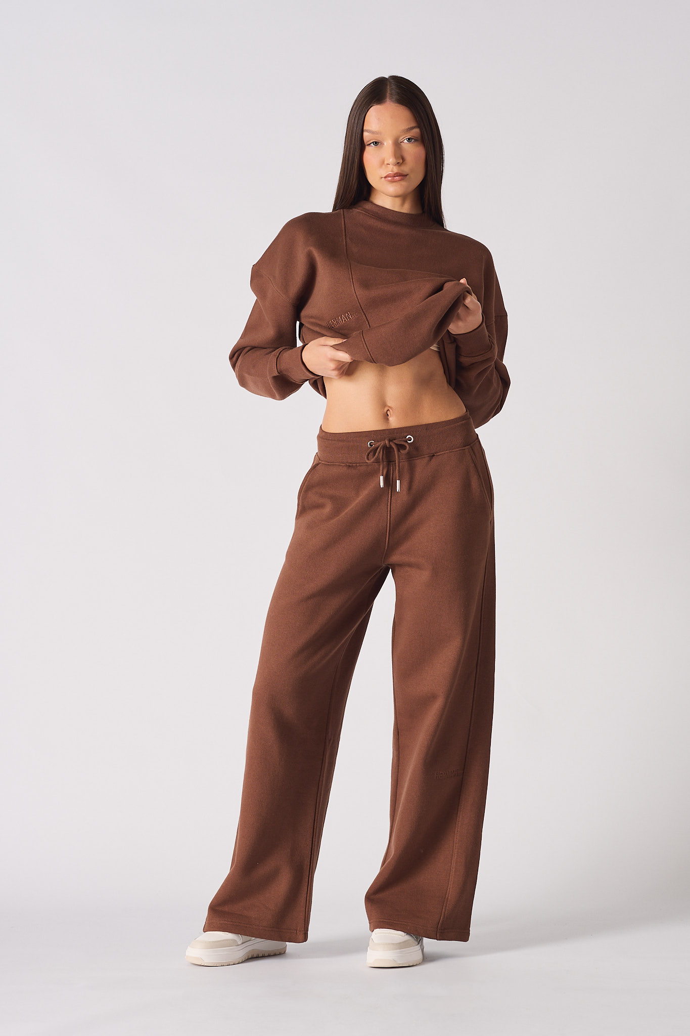 Full front view of a model wearing the women's brown joggers.