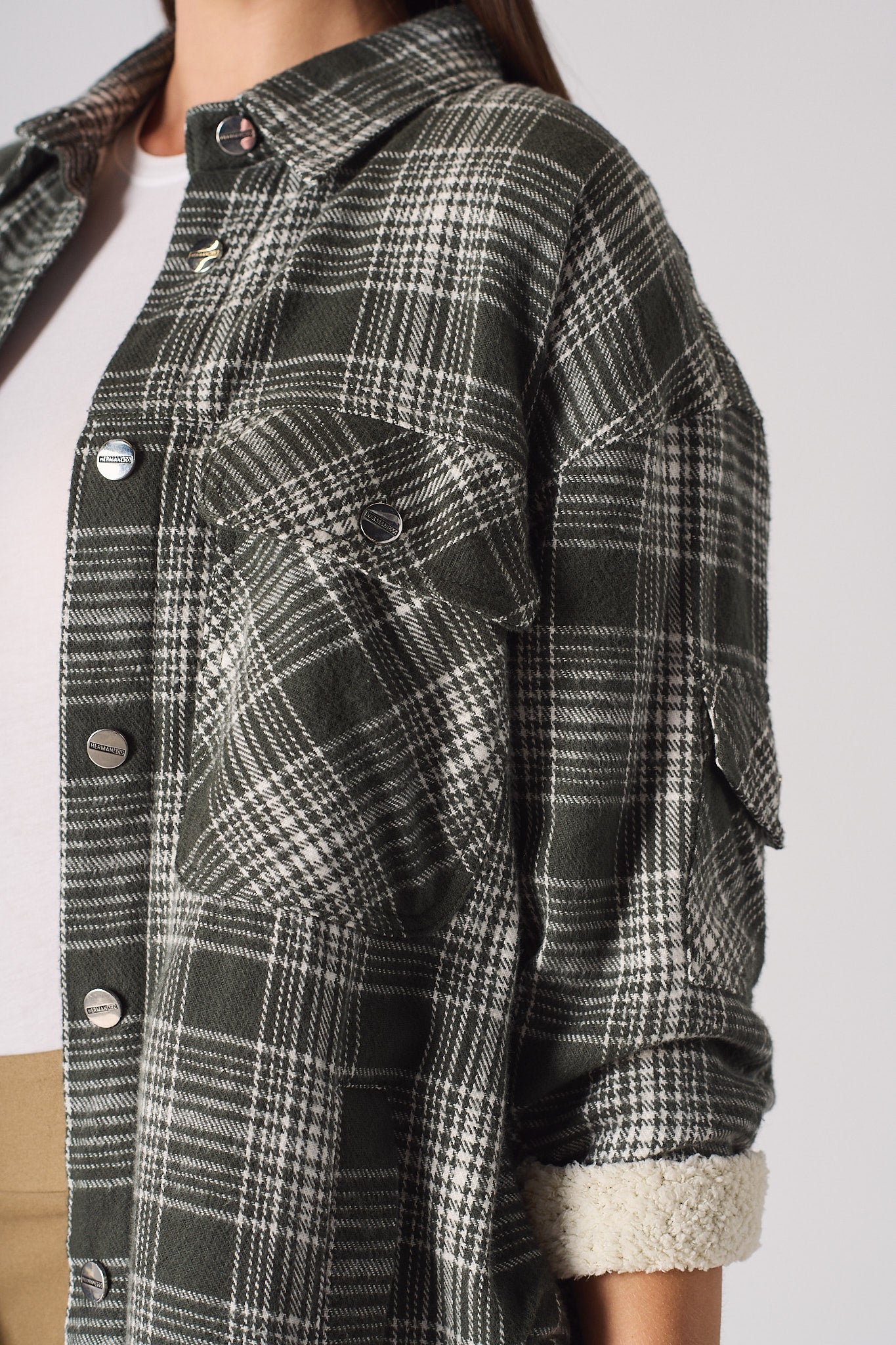 Detailed view of the rolled sleeve showing the fleece lining on the women's checked overshirt.