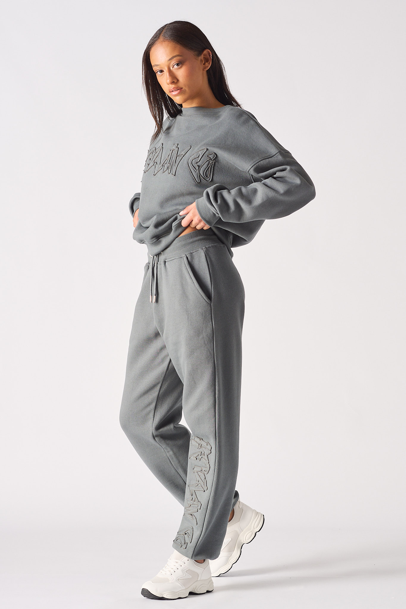 Model posing in a stylish womens oversized grey sweatshirt with a relaxed streetwear look