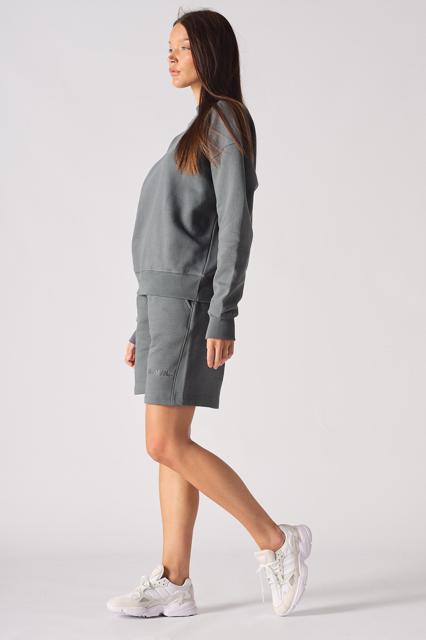 Full length view of women's grey crew neck jumper matching set outfit