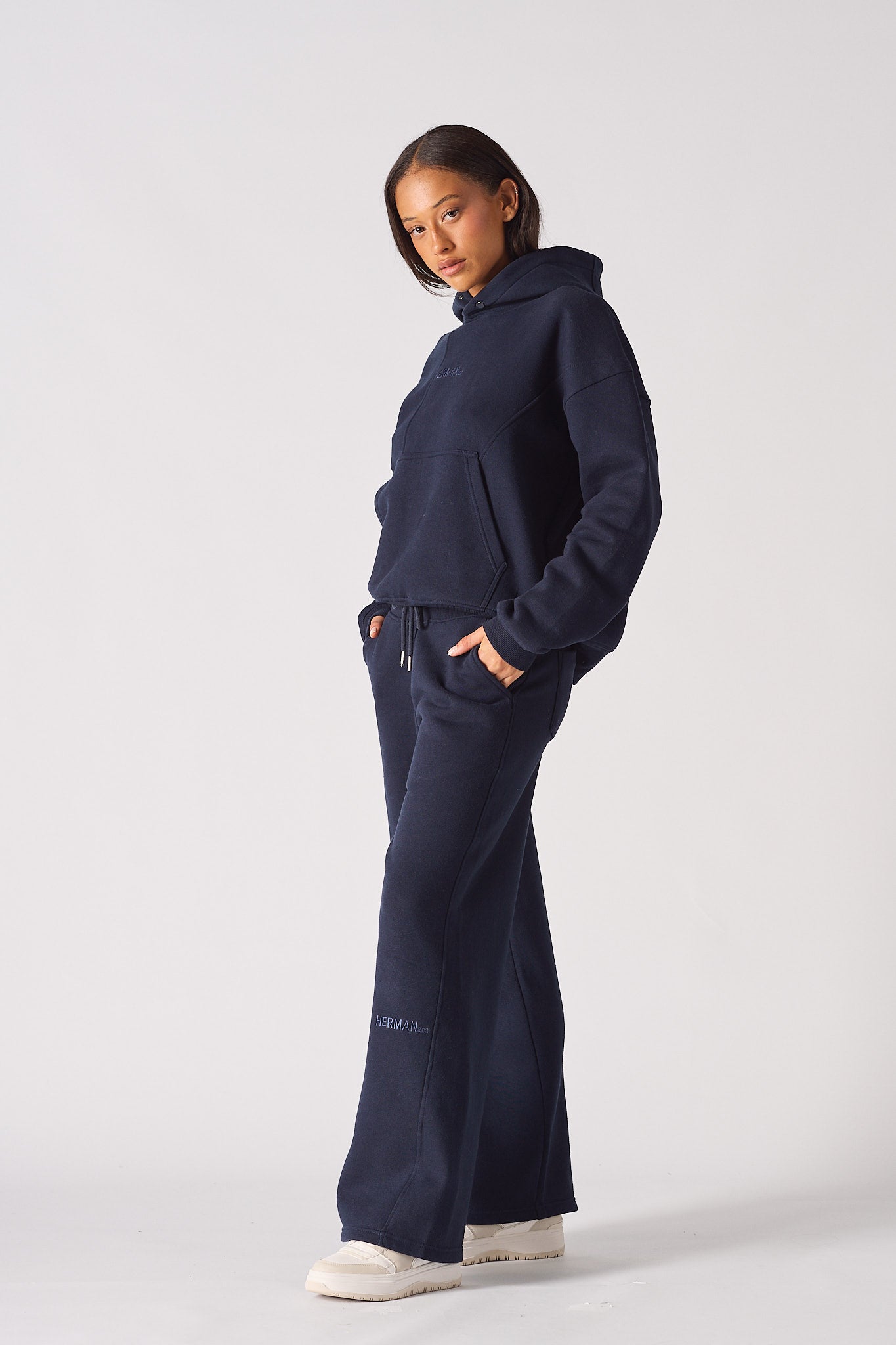 Side profile of a model wearing the women's navy wide-leg joggers.
