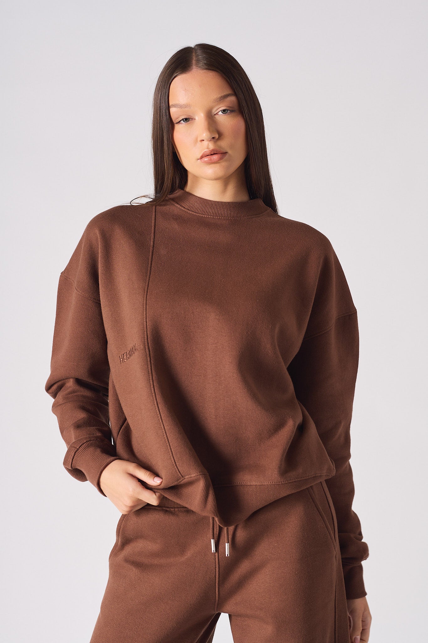 Mid shot of women wearing a comfortable brown crew neck jumper stylishly