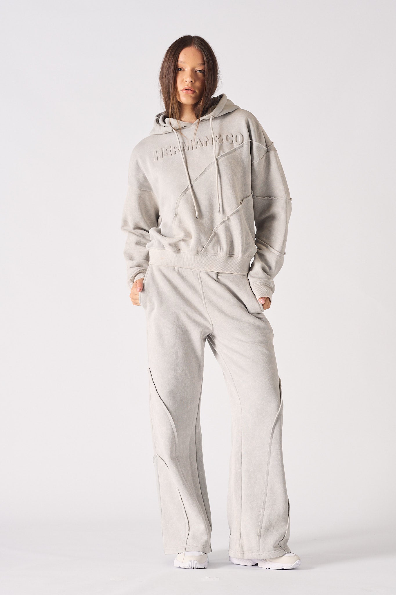 Front view of model wearing womens oversized grey hoodie with matching wide leg joggers