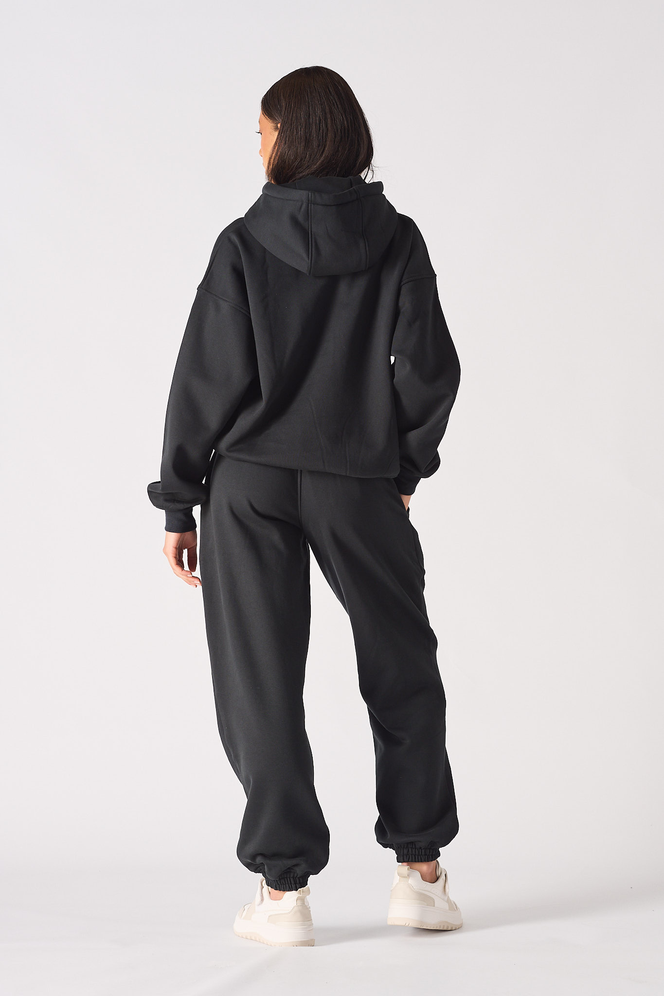 Model posing in a casual style wearing comfortable black oversized joggers