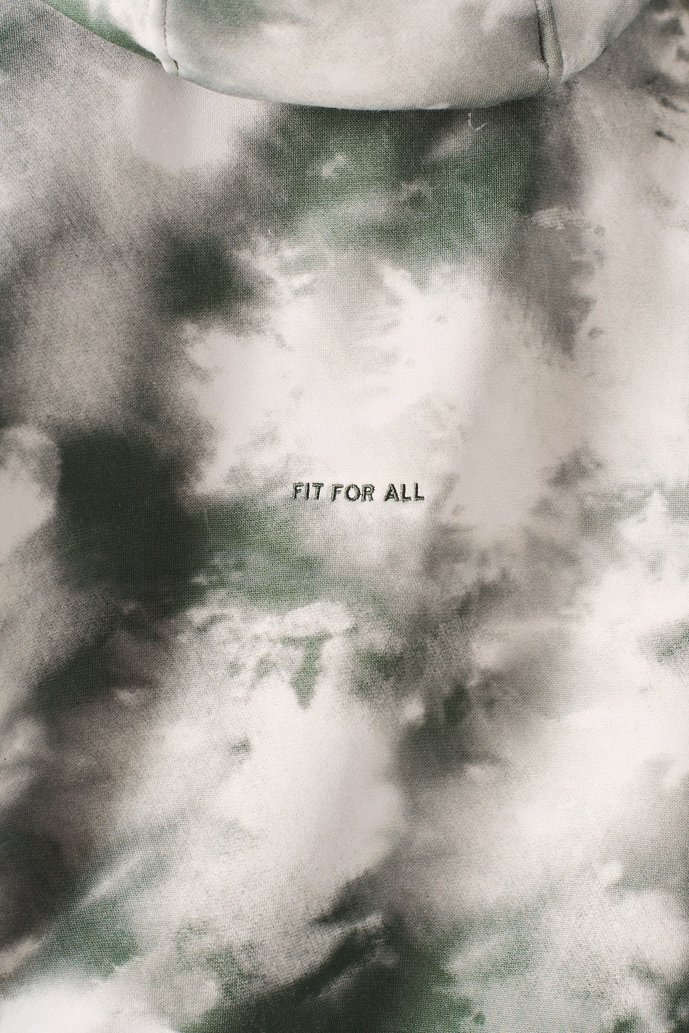 Close up angle showing the shoulder fit of the womens dark green tie dye hoodie