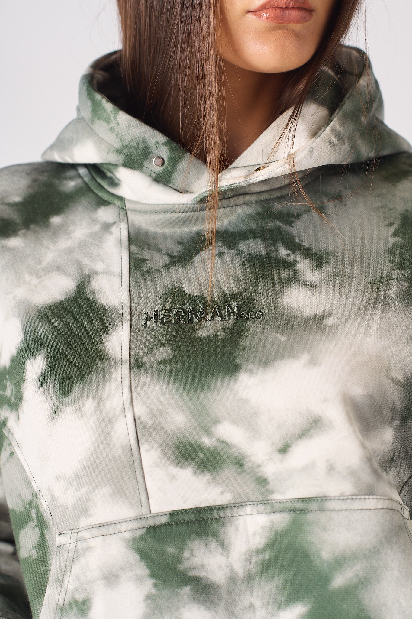 Detailed view of the ribbed sleeve cuff on womens dark green tie dye hoodie