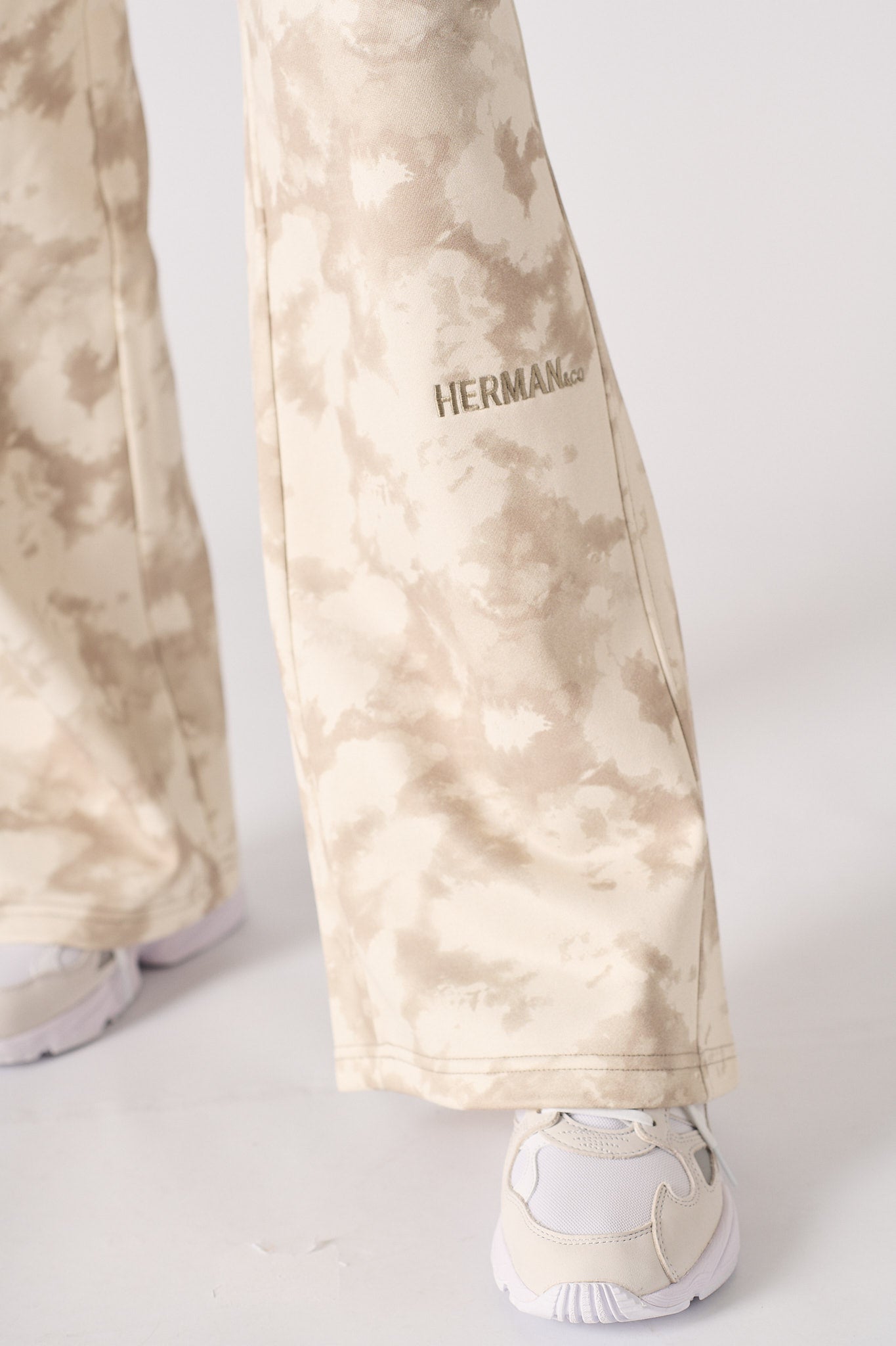 Back flat lay view of comfortable beige tie dye wide leg joggers