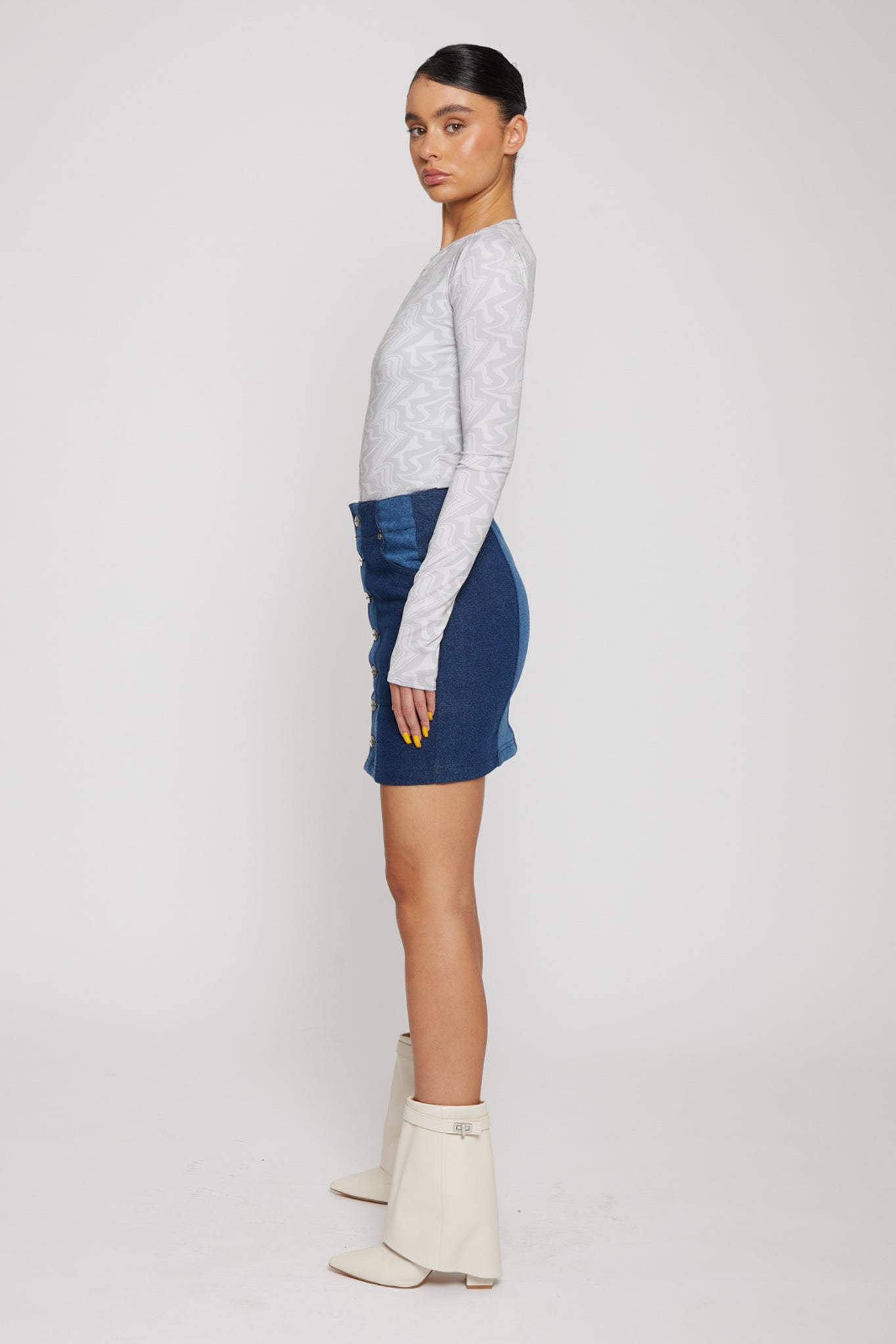 Side profile of a model showing the fit of the abstract print bodysuit.