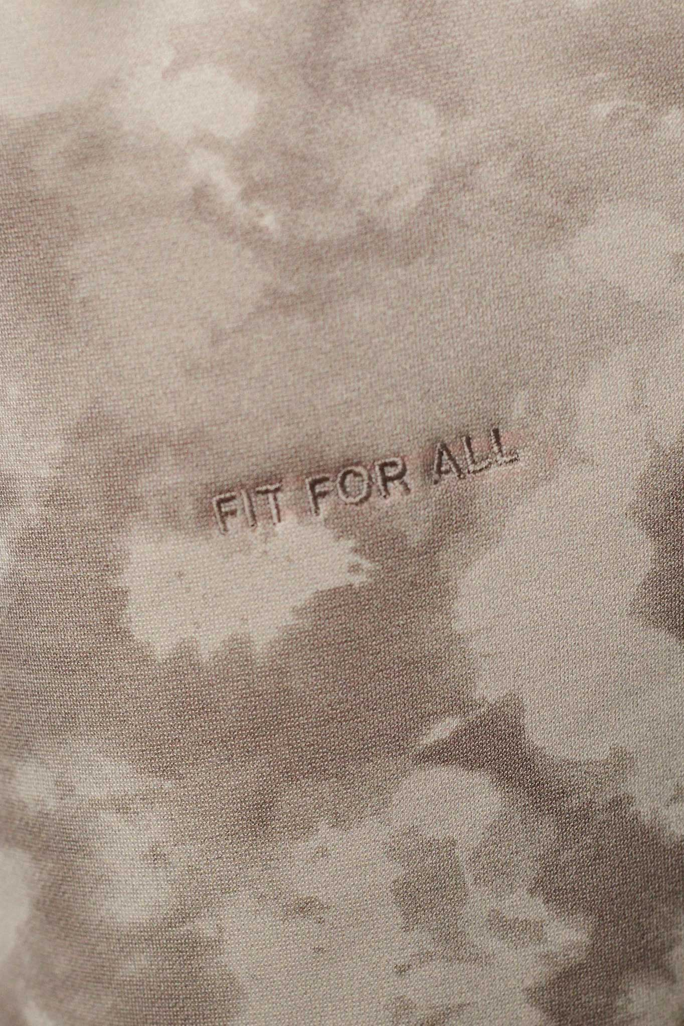 Close up texture view of the beige tie dye fabric and branding