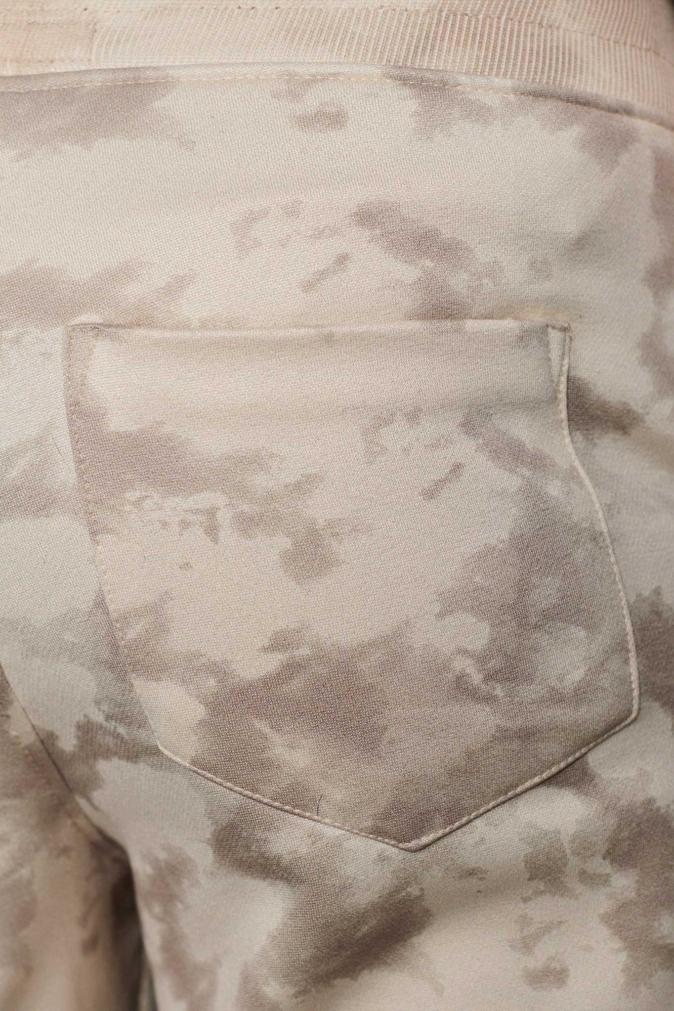 Detailed view of the back pocket on mens beige wide leg trousers