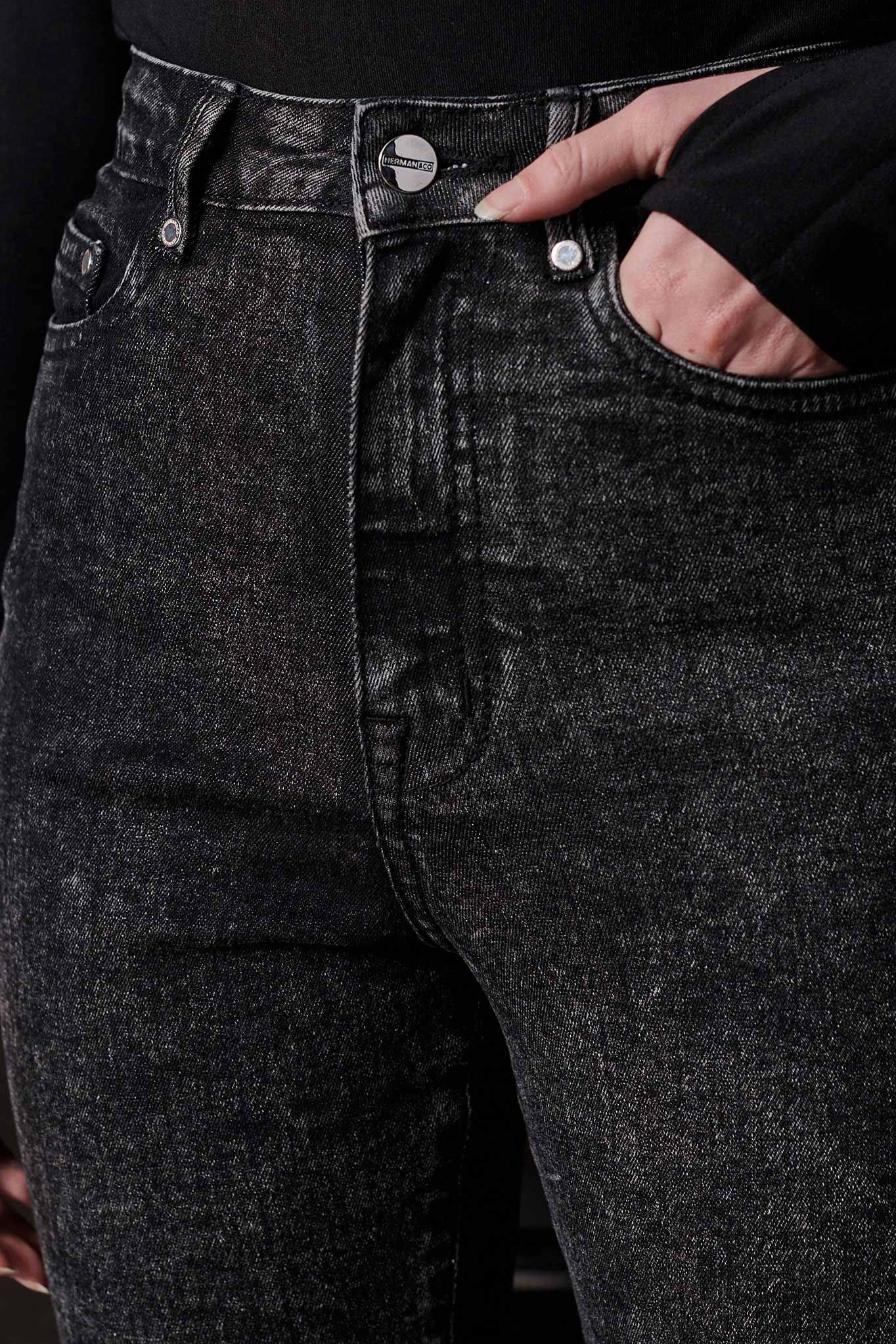 A close-up view of the black acid wash fabric and texture on the jeans