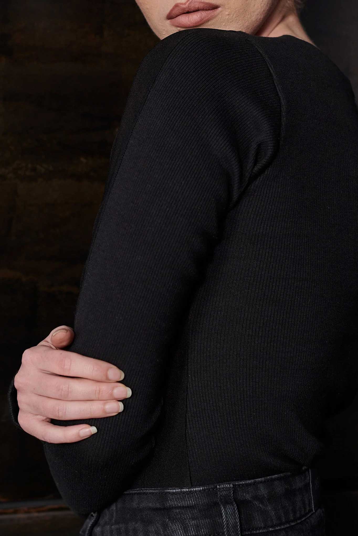 Close-up of the sleeve on the women's black t-shirt body suit.