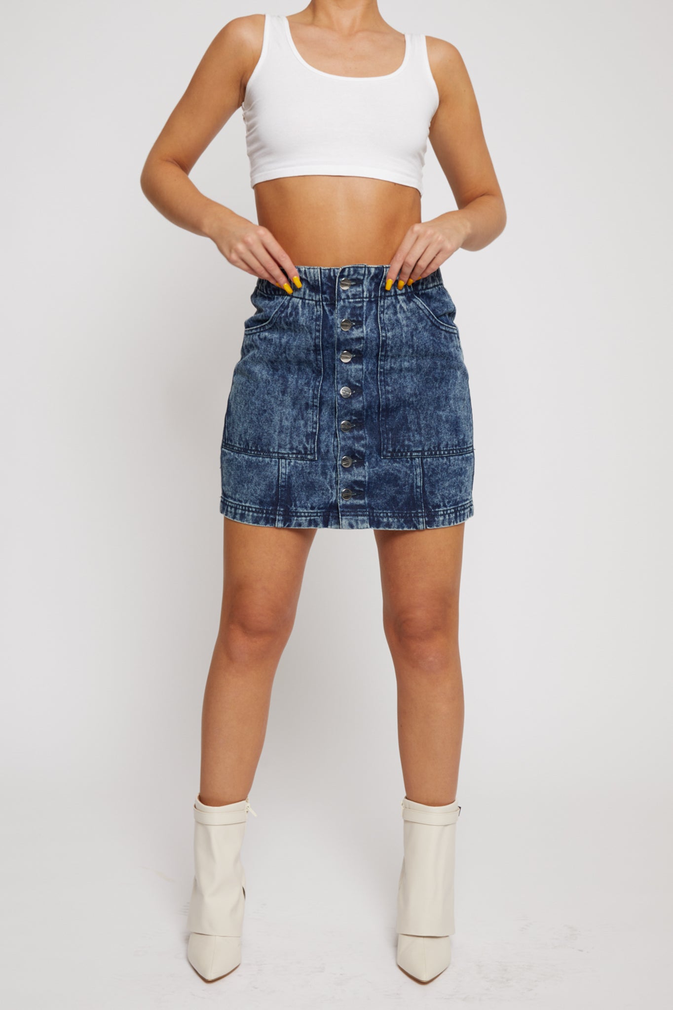 Front view of the women's blue acid wash denim skirt with a button front