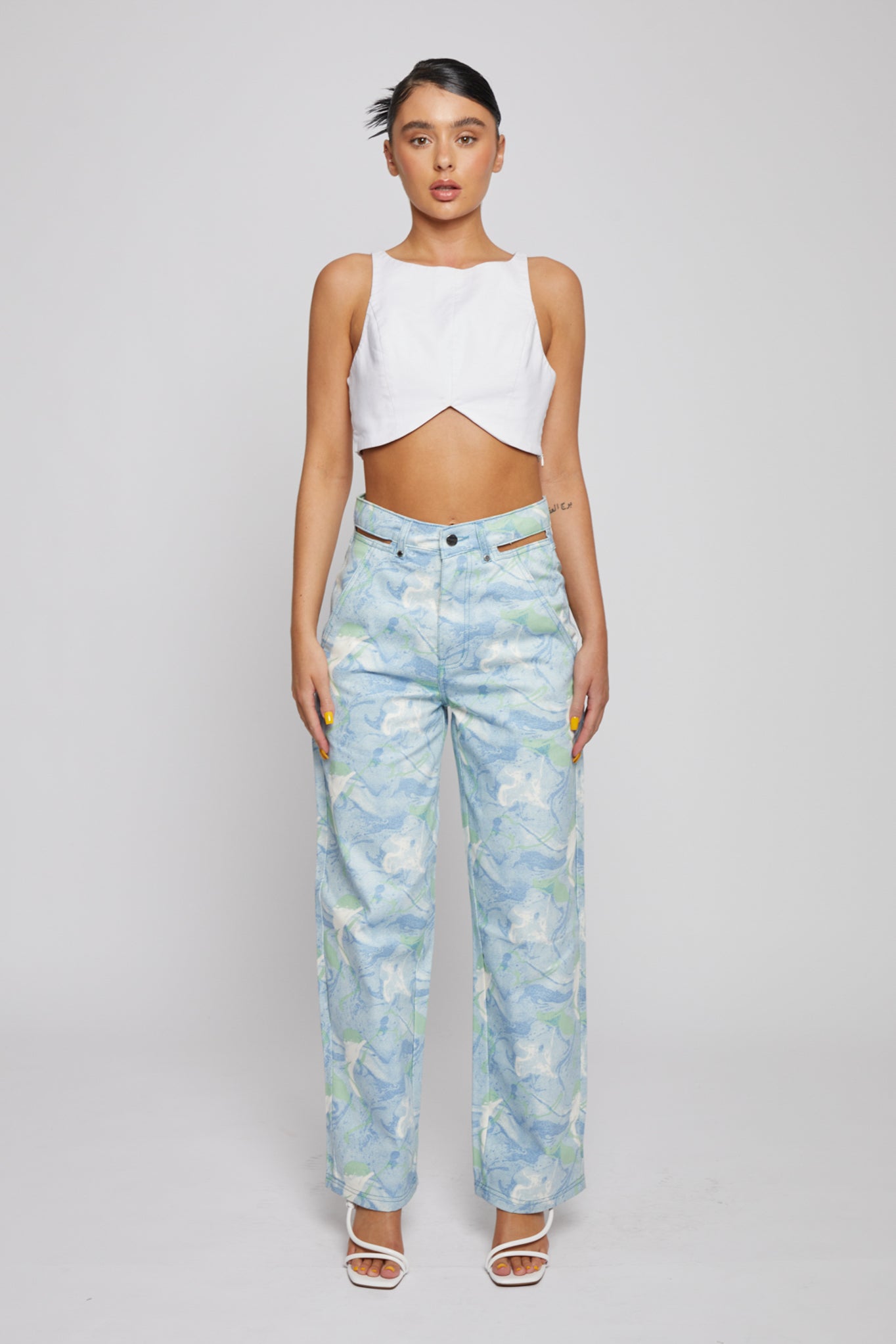 Full front view of a model in the blue psychedelic marble print jeans.