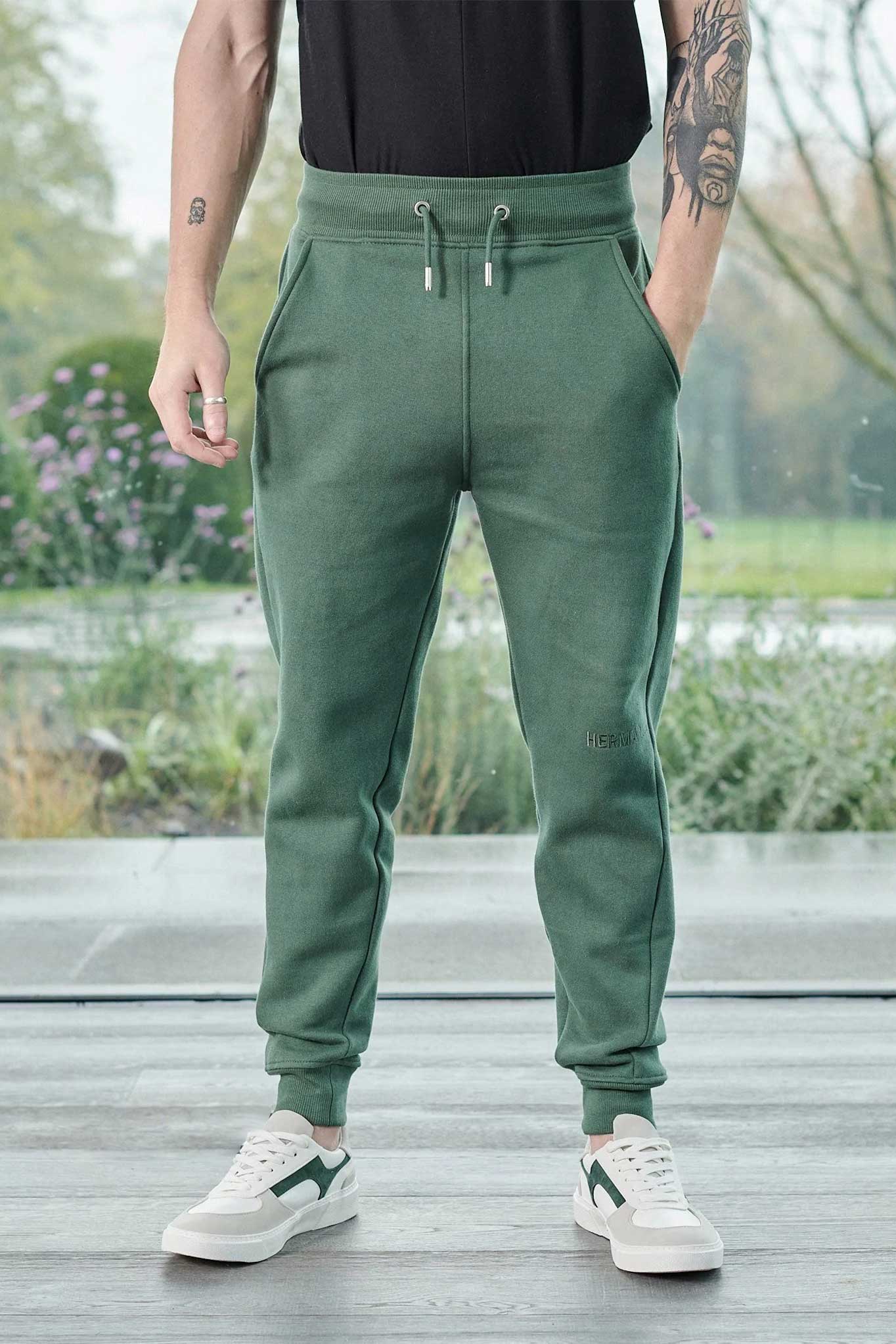 Close up detail of the drawstring waist and pockets on dark green joggers mens