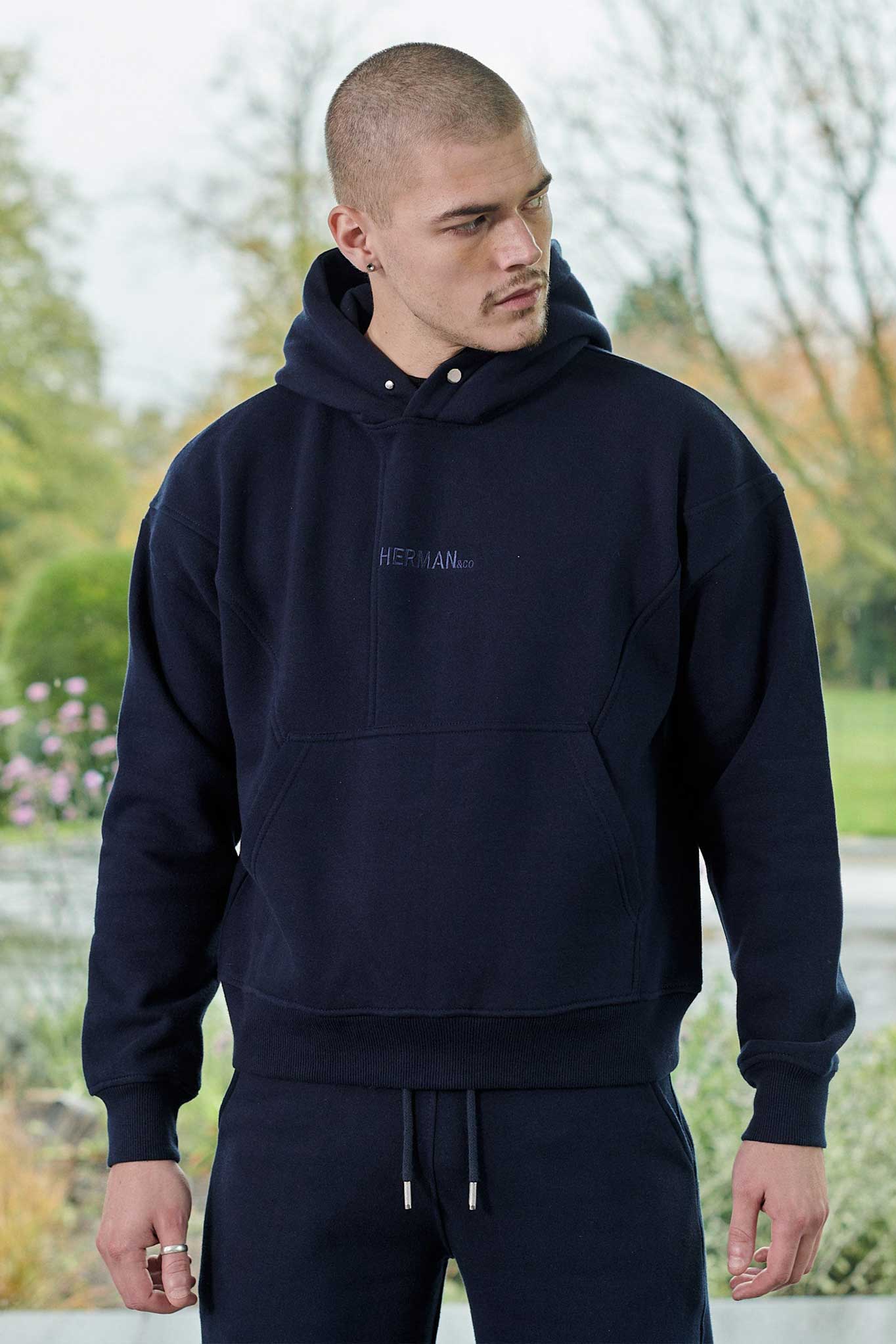Rear full body view of mens dark navy hoodie showing relaxed fit