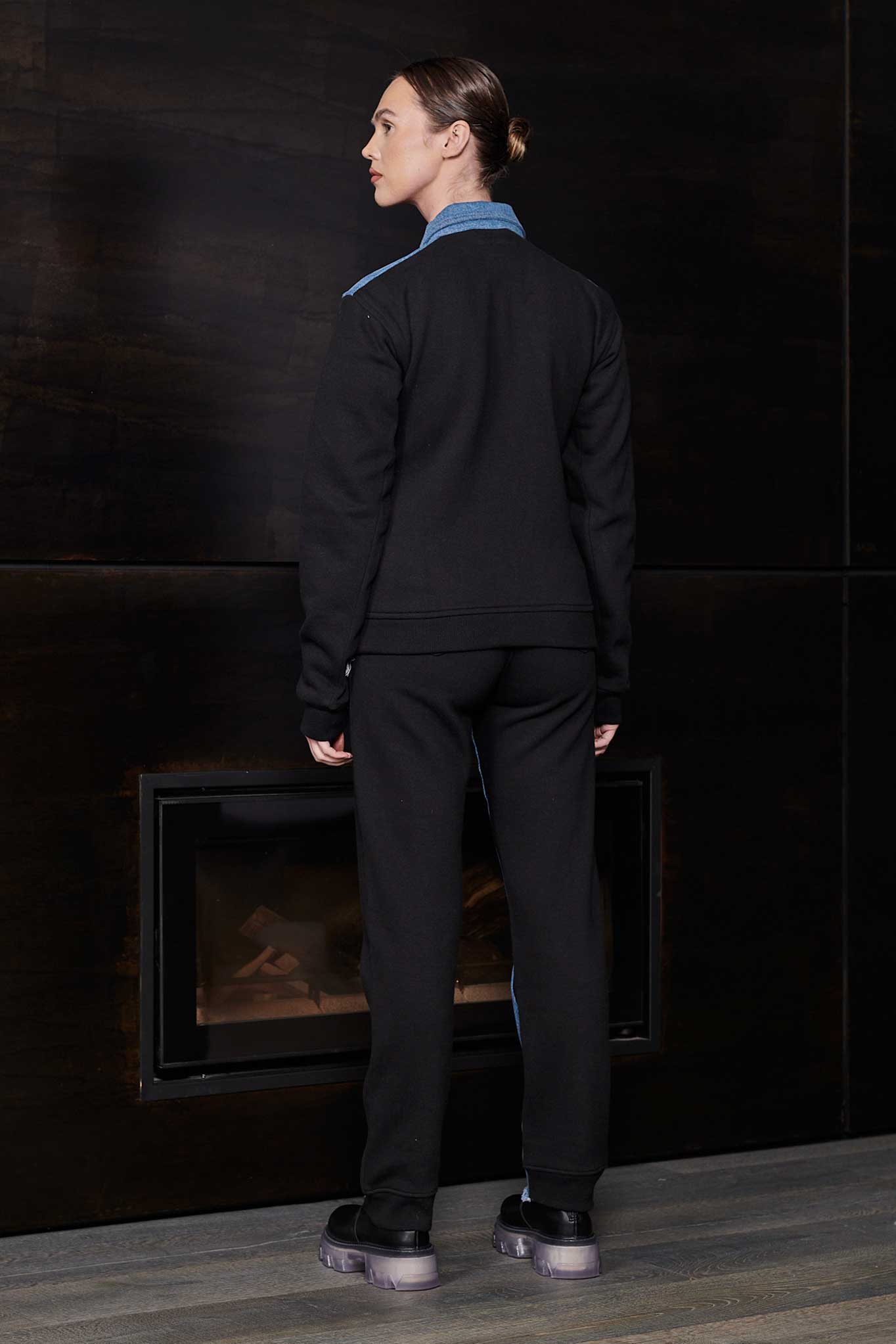 Back view of a model in the denim and fleece jacket for women.