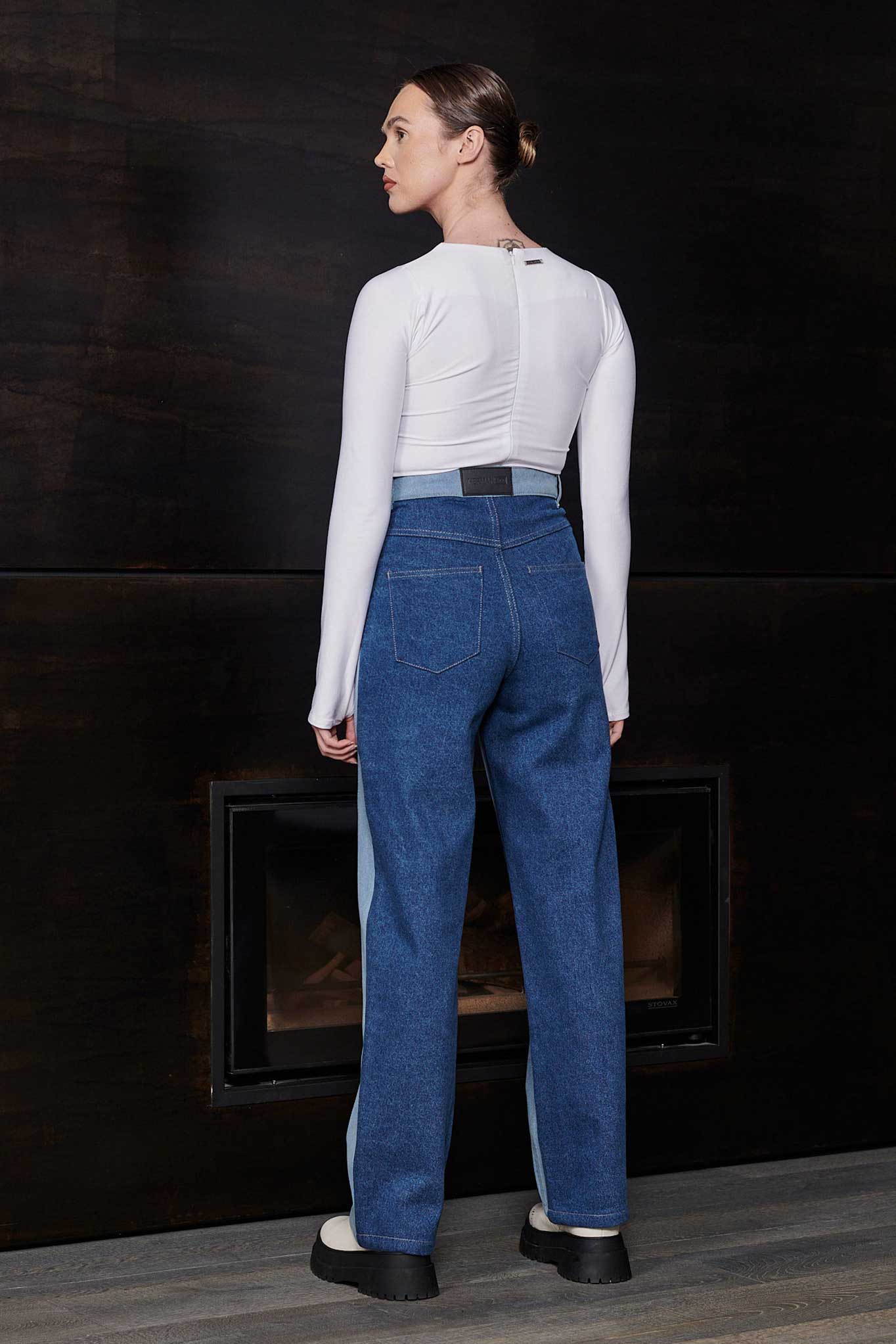 Back view of a model showing the dark wash panel on the half wash jeans.