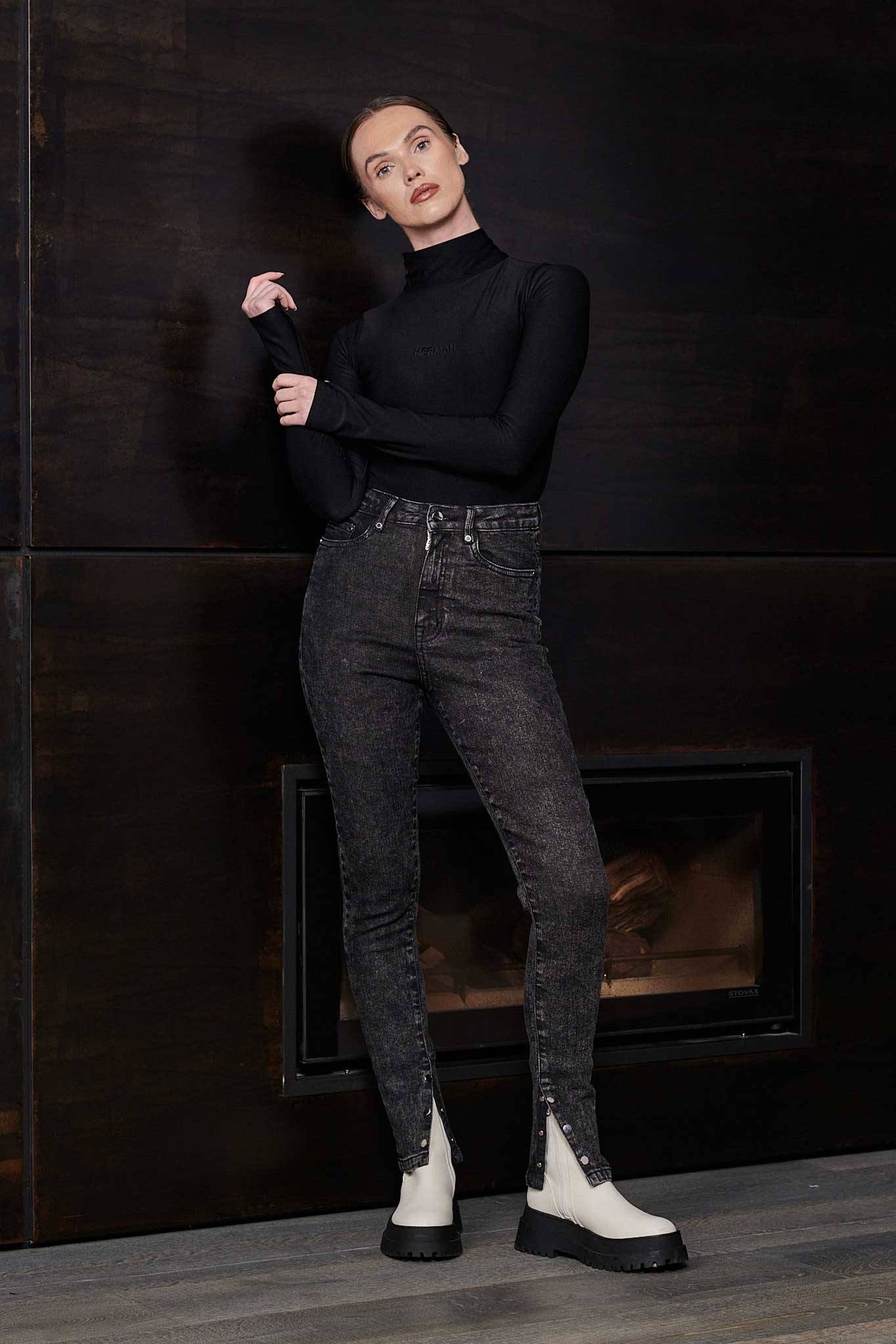 Model posing in Herman & Co black acid wash skinny jeans