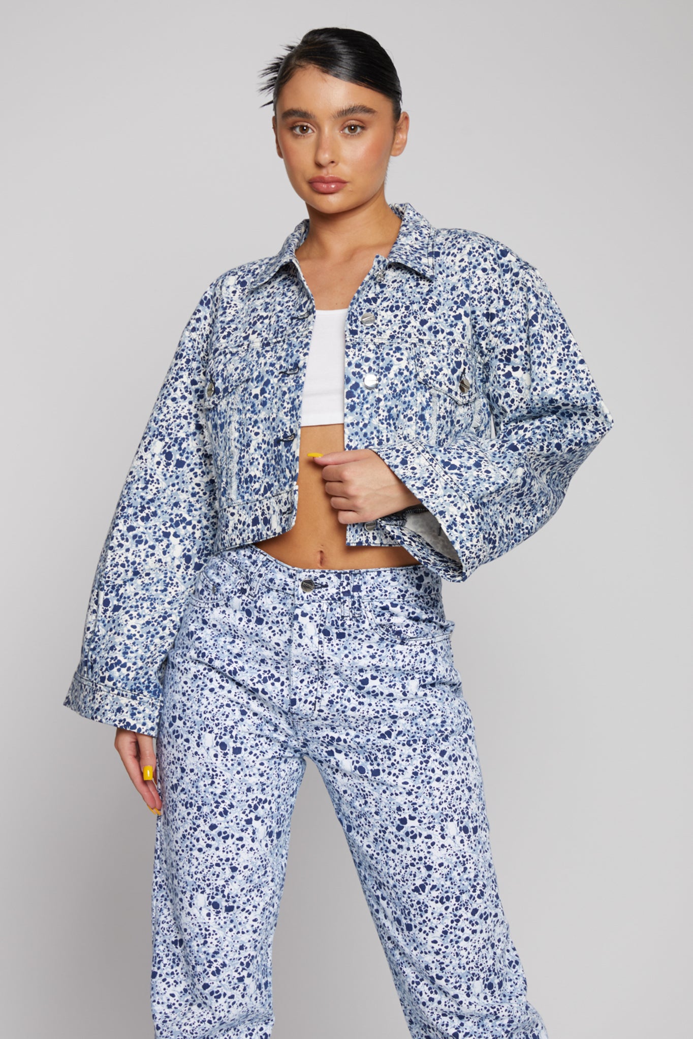 Model wearing the marble print cropped denim jacket with matching jeans.