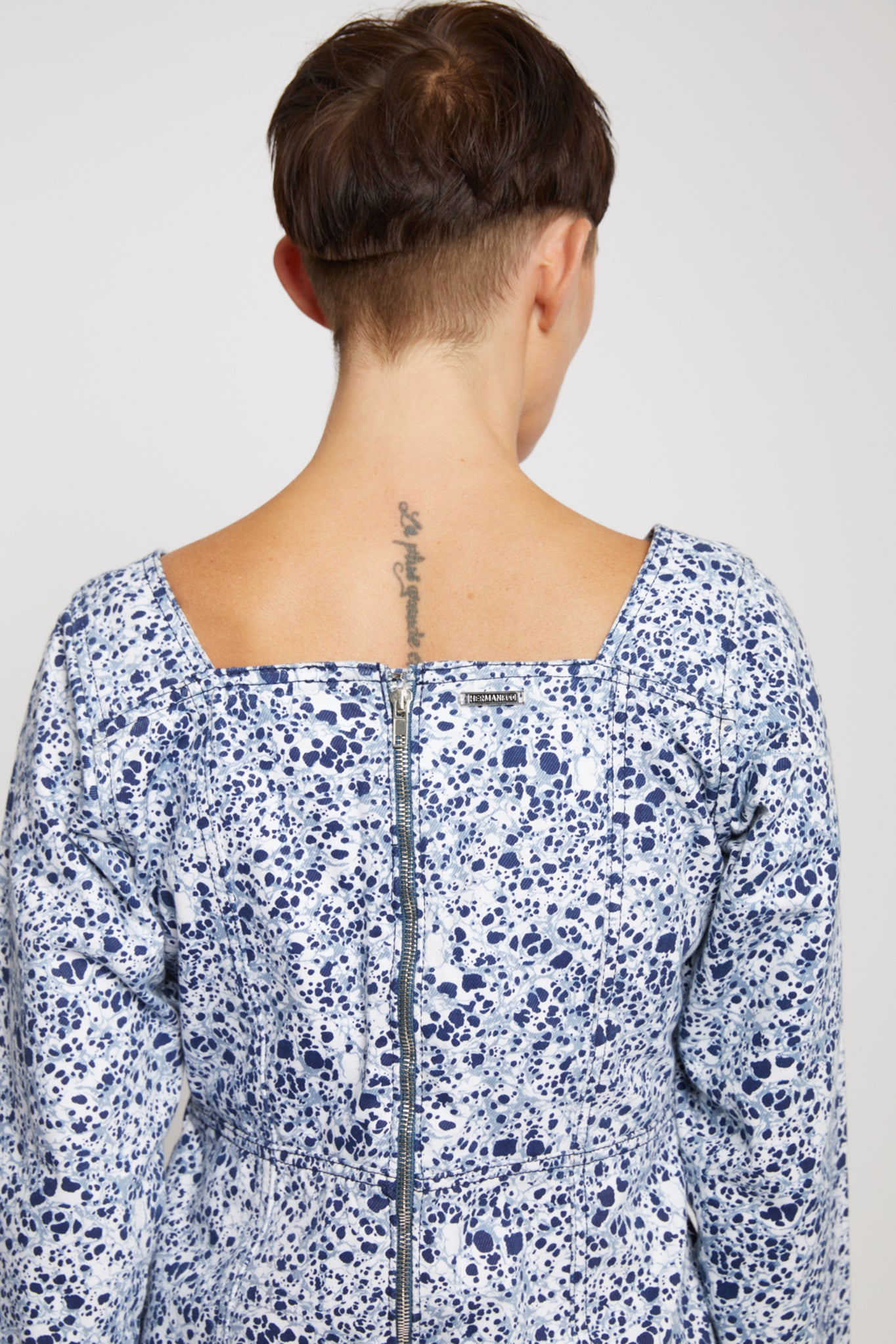 Close-up of the back showing the zip detail on the marble print lace-up top.