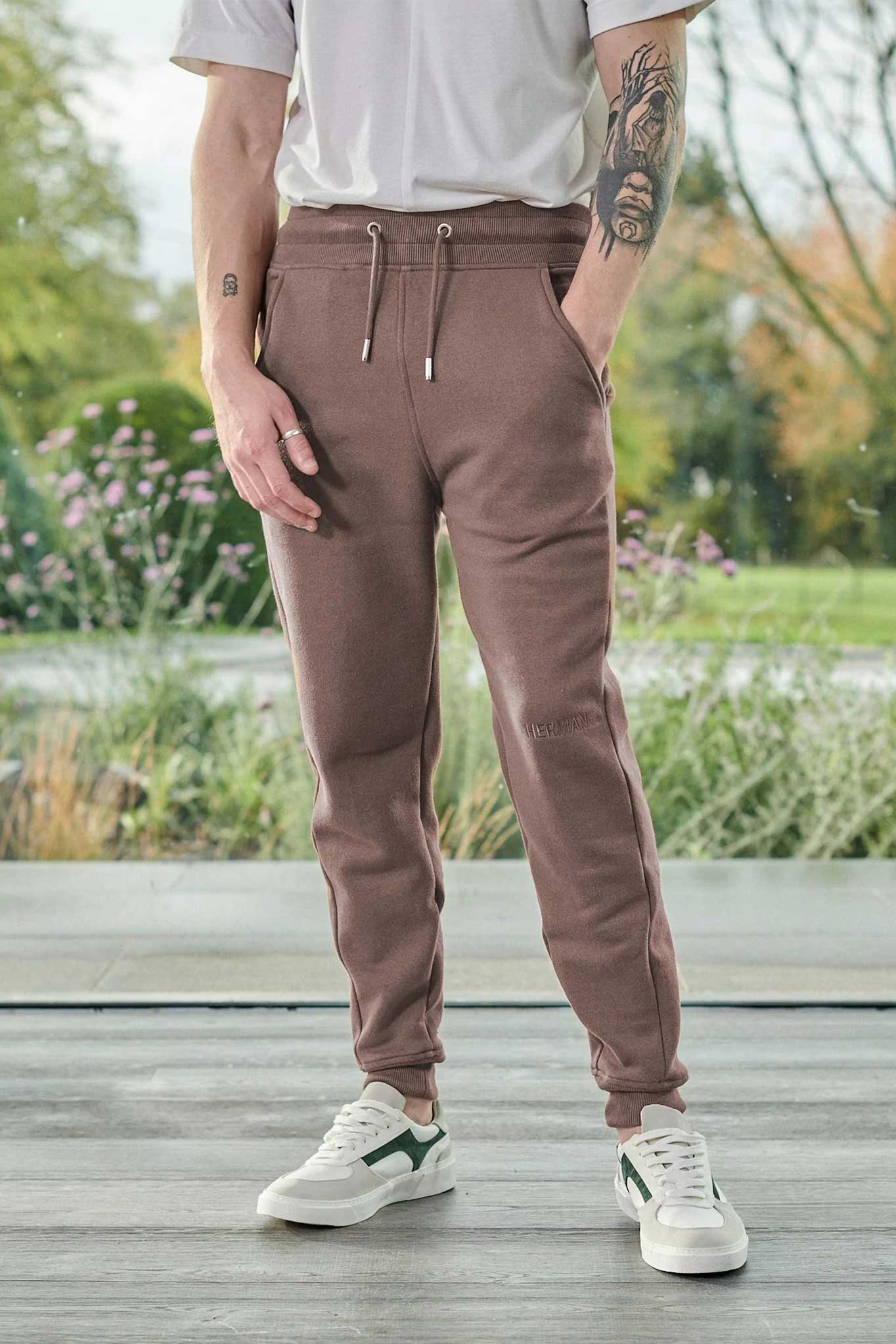 Close-up of the men's brown tapered joggers showing the fit and cuffed ankle.