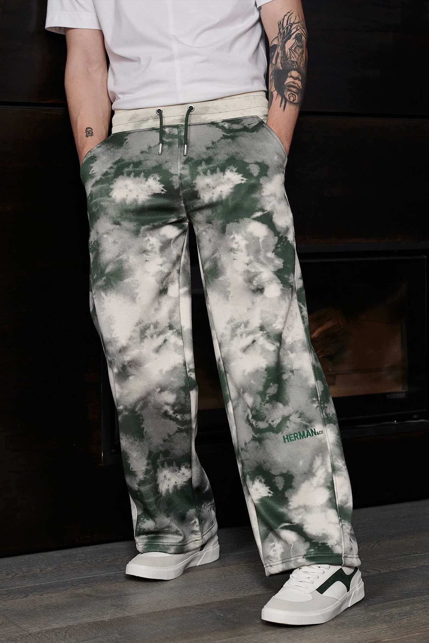 Close-up of the men's dark green and white tie-dye wide-leg joggers.
